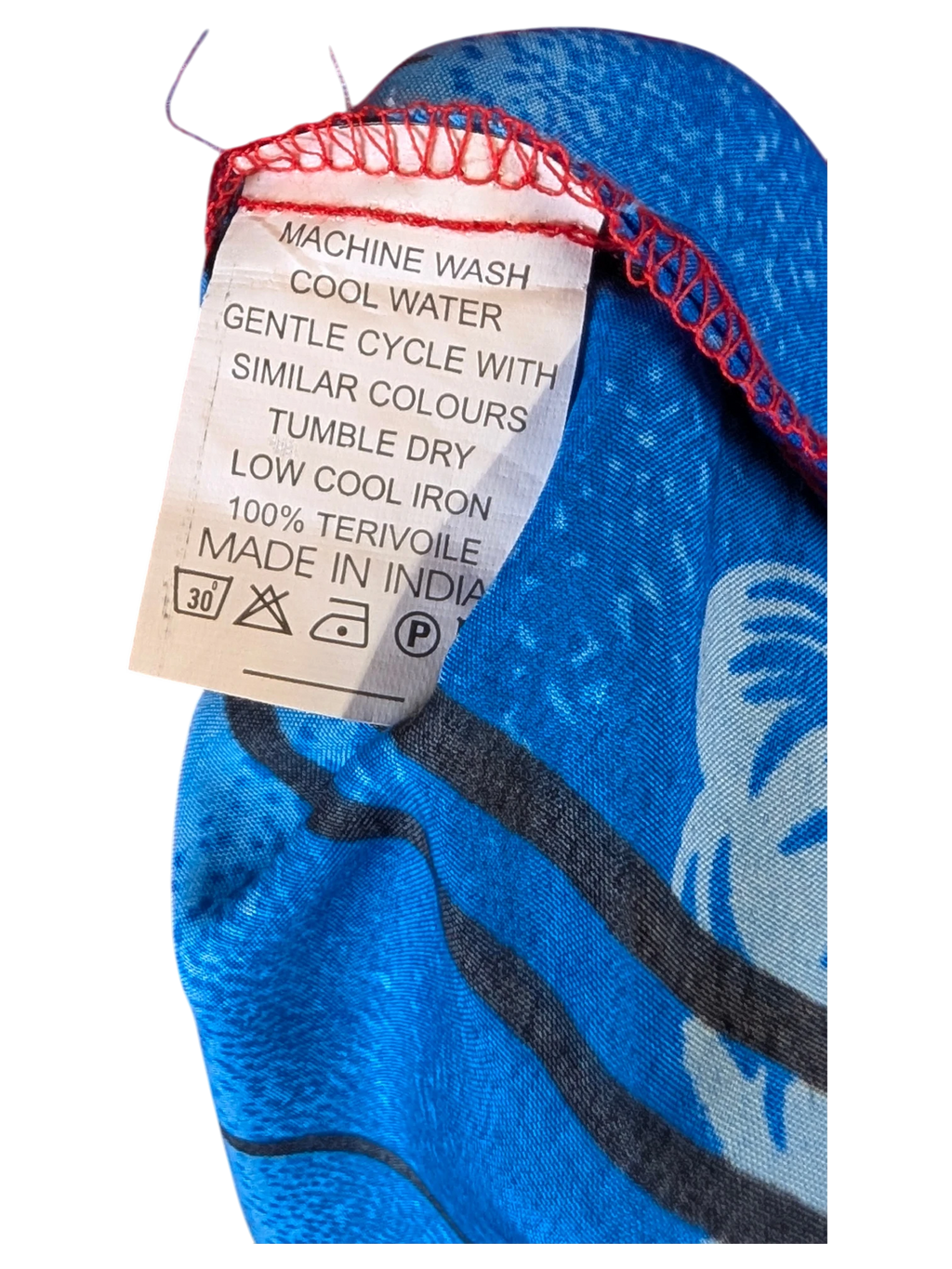 JAKE & IPI red Hawaiian shirt care label showing 100% terivoile fabric and washing instructions