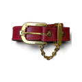 JAKE & IPI red leather belt featuring a polished gold buckle and decorative gold chain detail held in a hand.