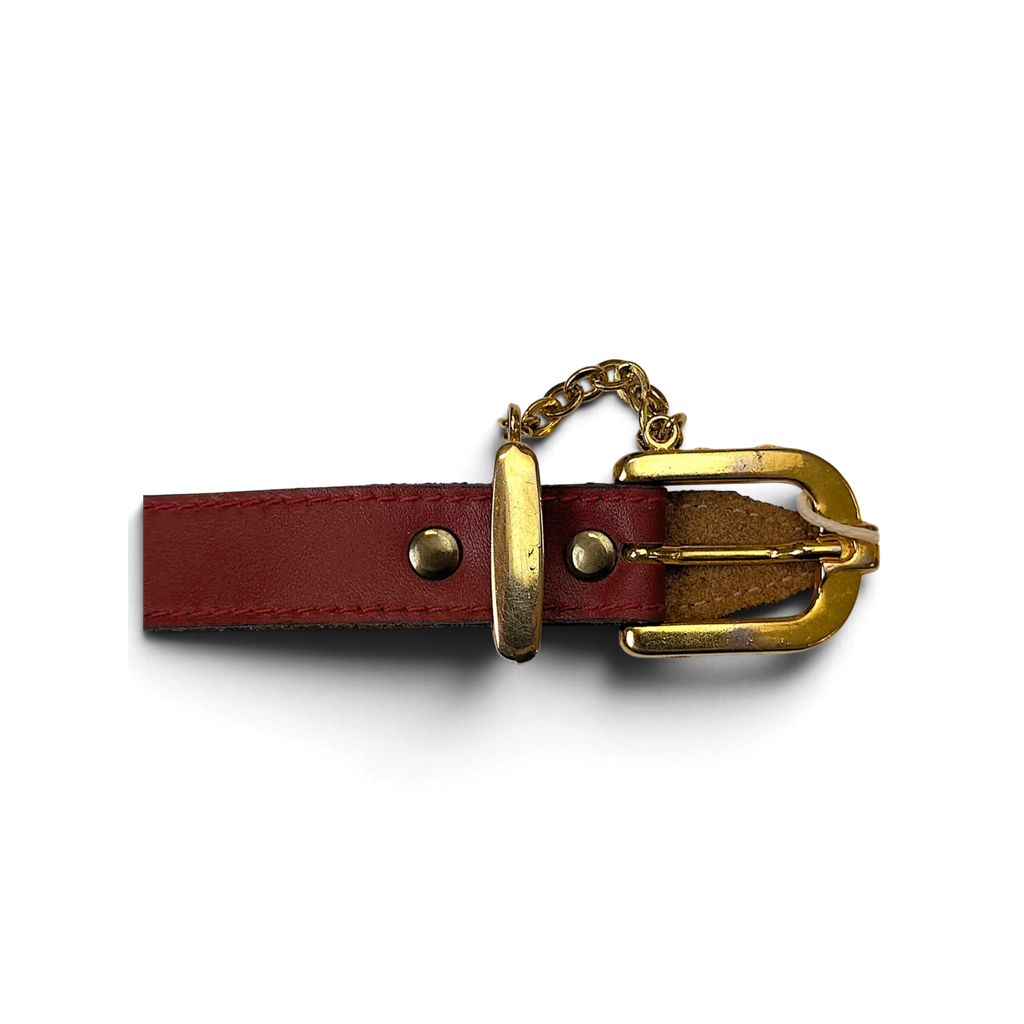 JAKE & IPI red leather belt featuring a polished gold-tone buckle and decorative chain hardware detail.
