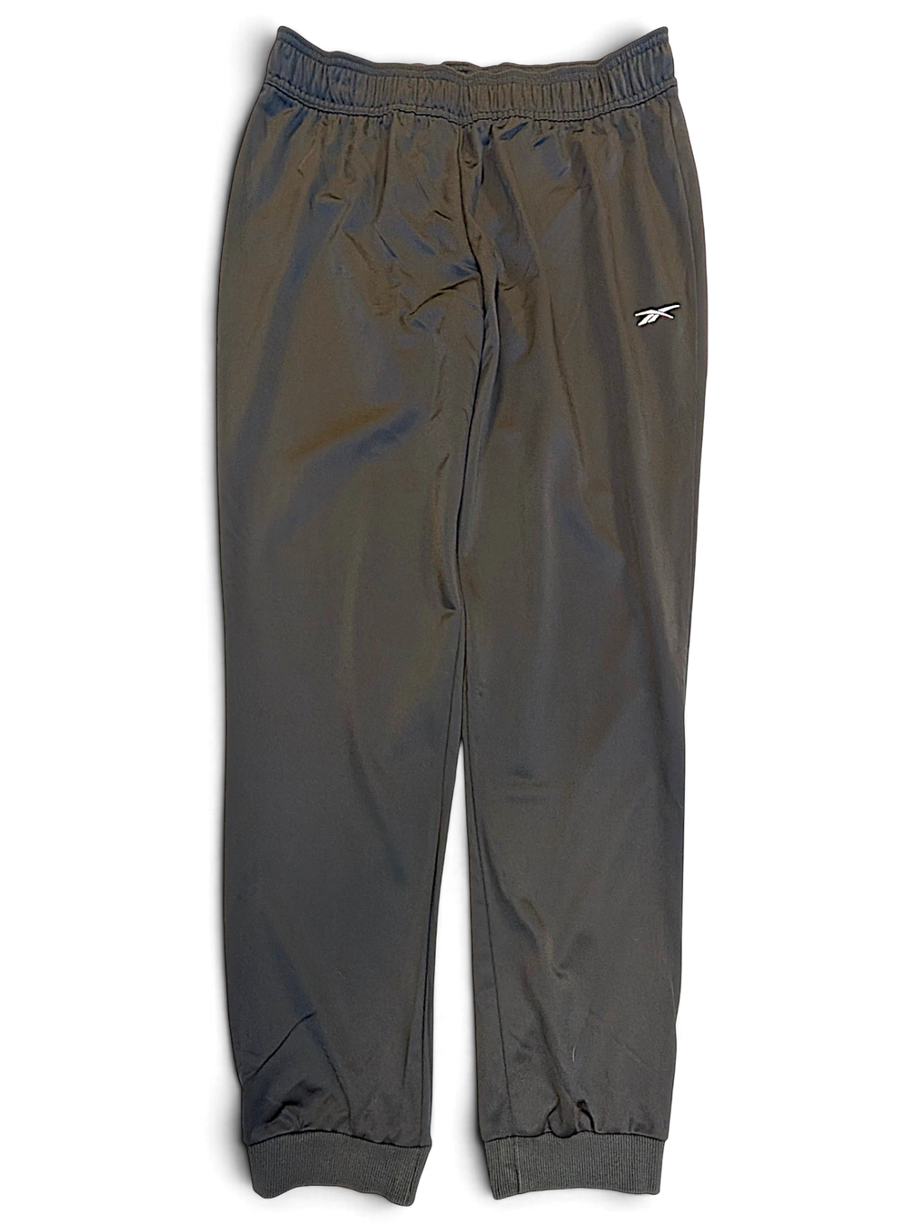 JAKE & IPI pre-owned black Reebok track pants with tapered fit, cuffed ankles, and white logo detail.