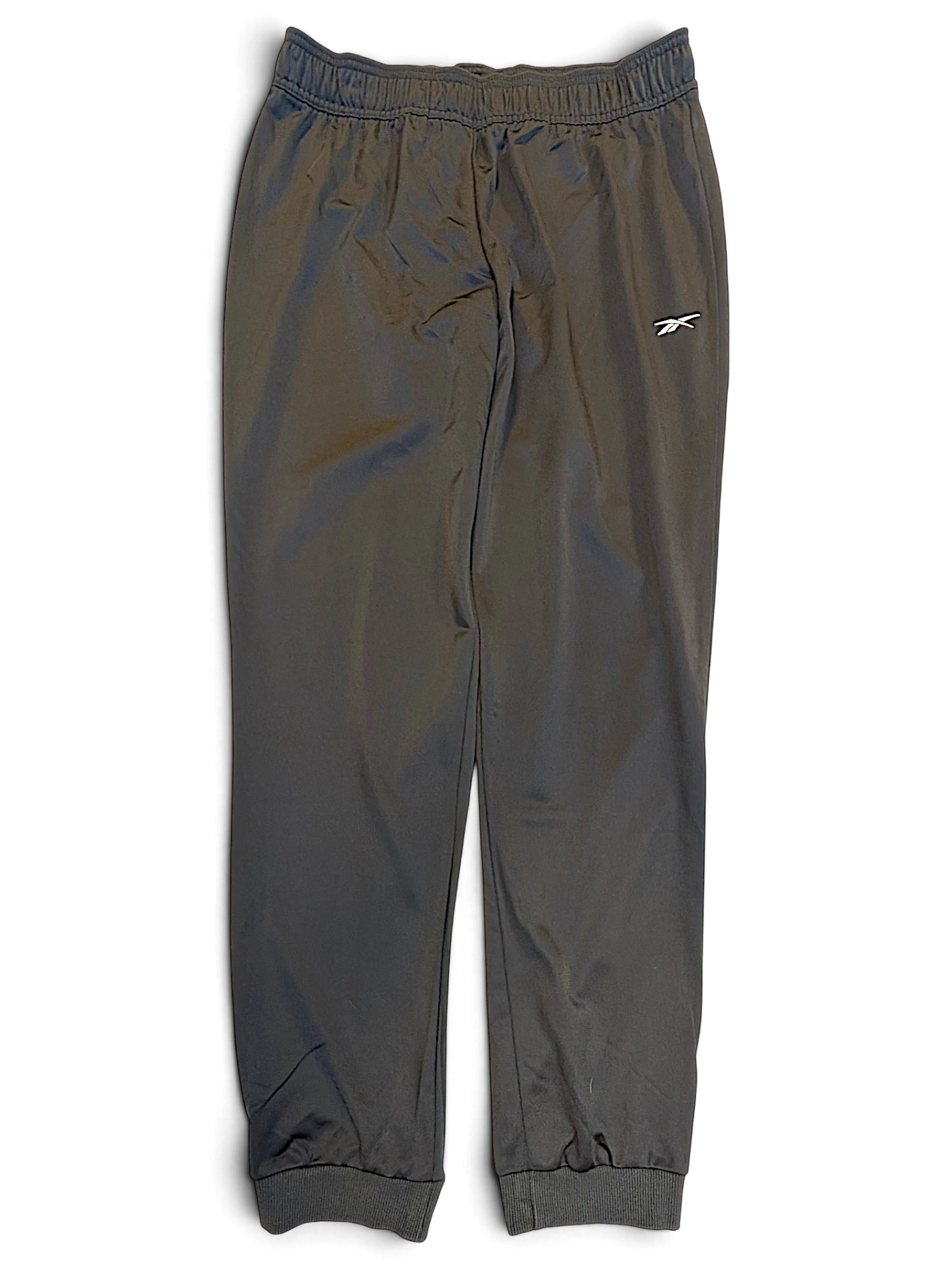 JAKE & IPI pre-owned black Reebok track pants with tapered fit, cuffed ankles, and white logo detail.