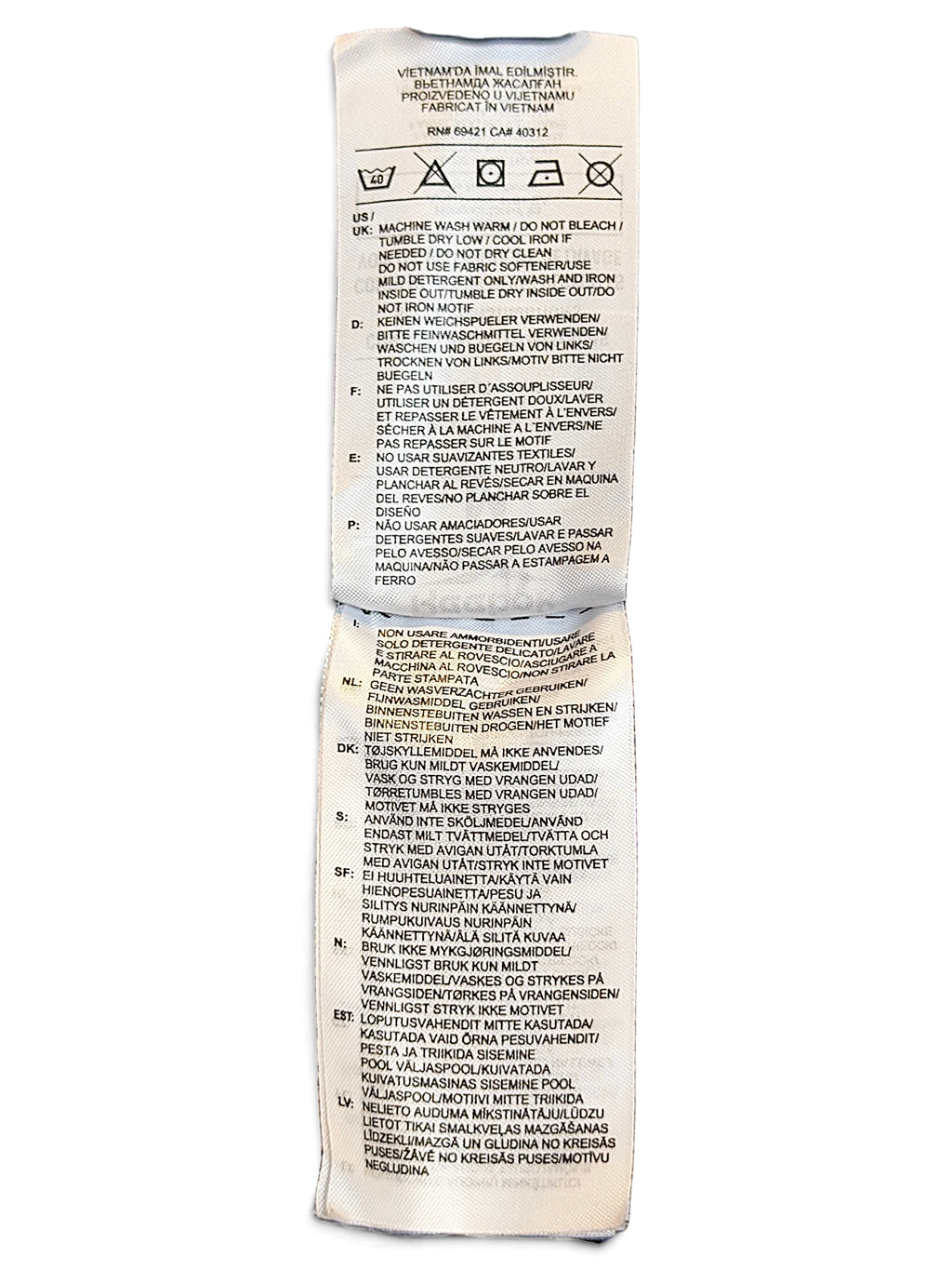 JAKE & IPI Reebok track pants care label with washing instructions in multiple languages