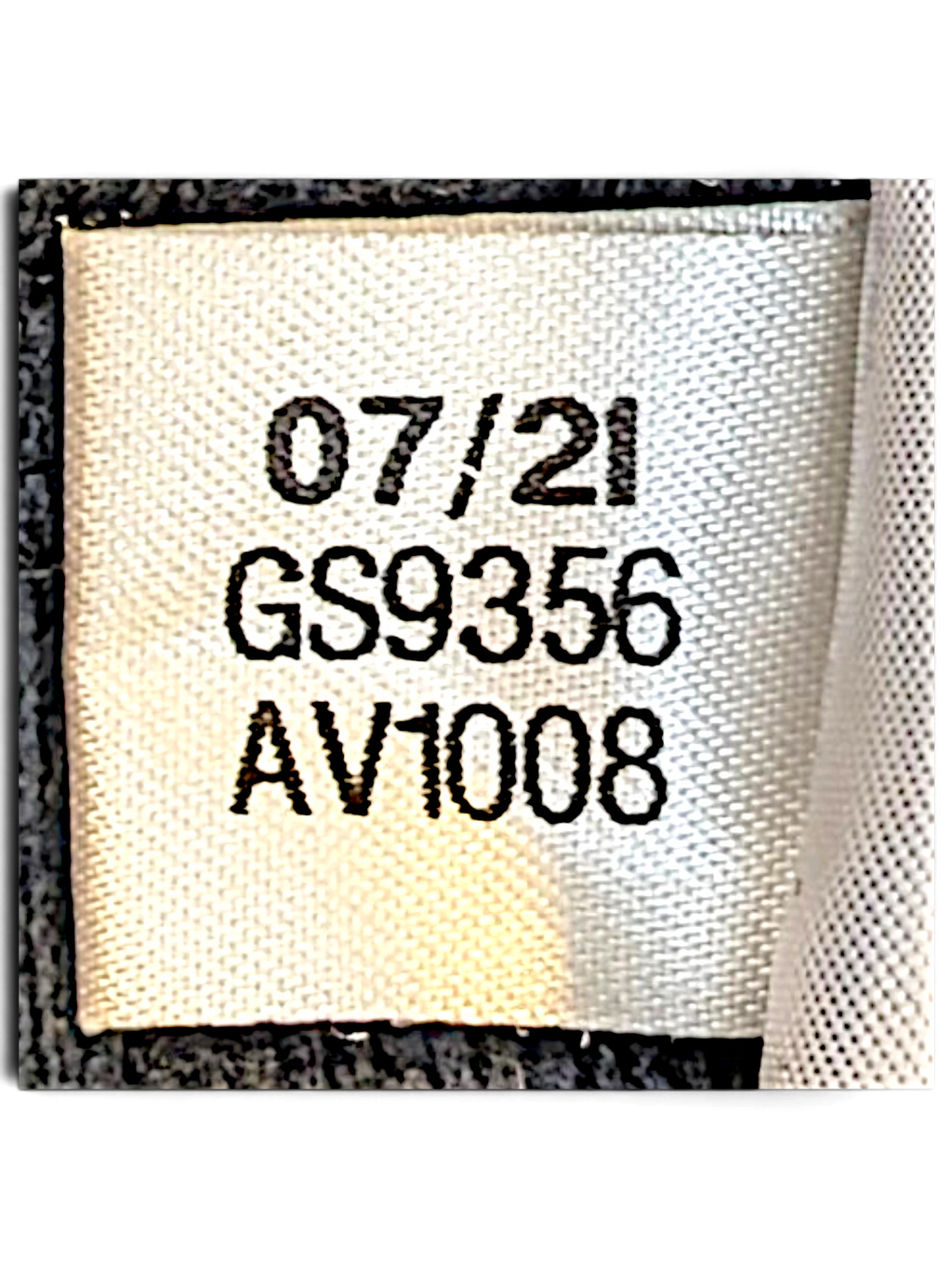 JAKE & IPI Reebok track pants fabric care label showing production date 07/21 and style code GS9356