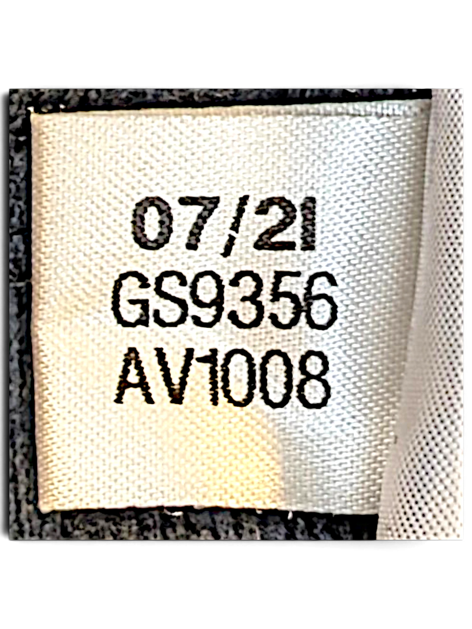 JAKE & IPI Reebok track pants fabric care label showing production date 07/21 and style code GS9356