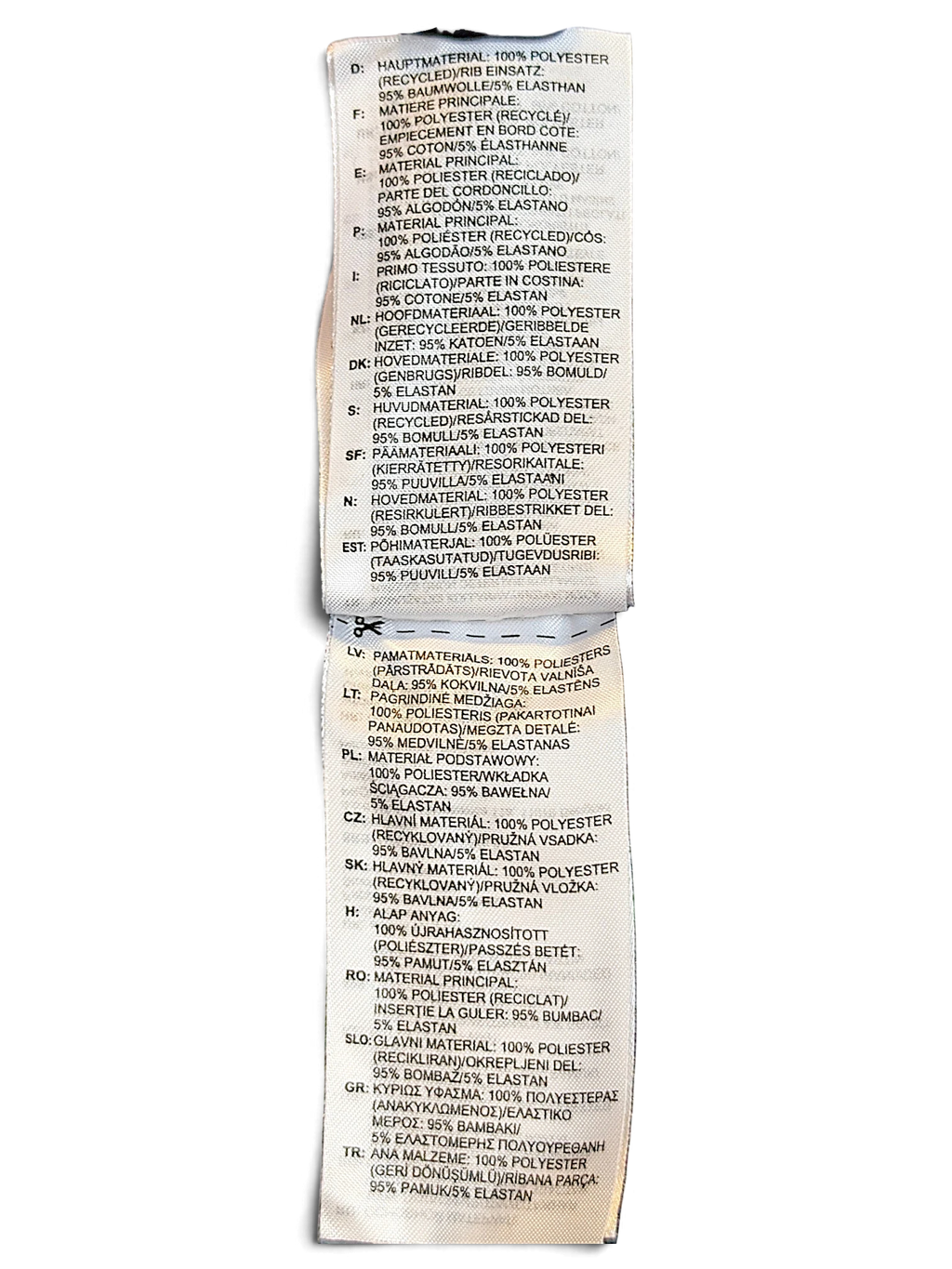 JAKE & IPI Reebok track pants care label detailing polyester composition and recycled material information