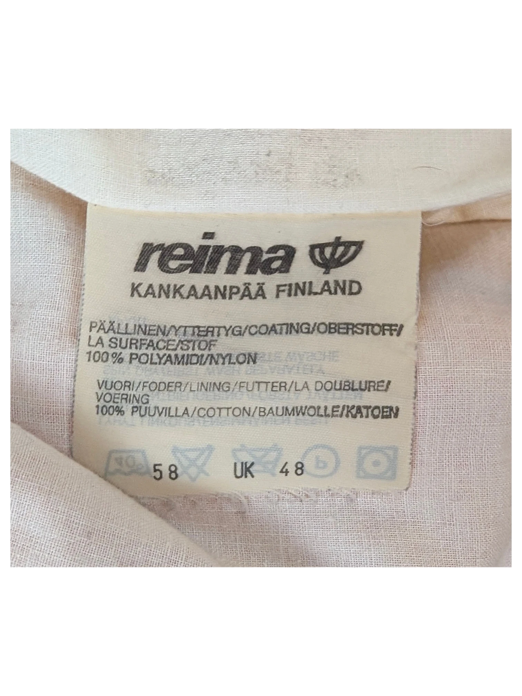 JAKE & IPI Reima clothing label showing 100% nylon outer and 100% cotton lining details
