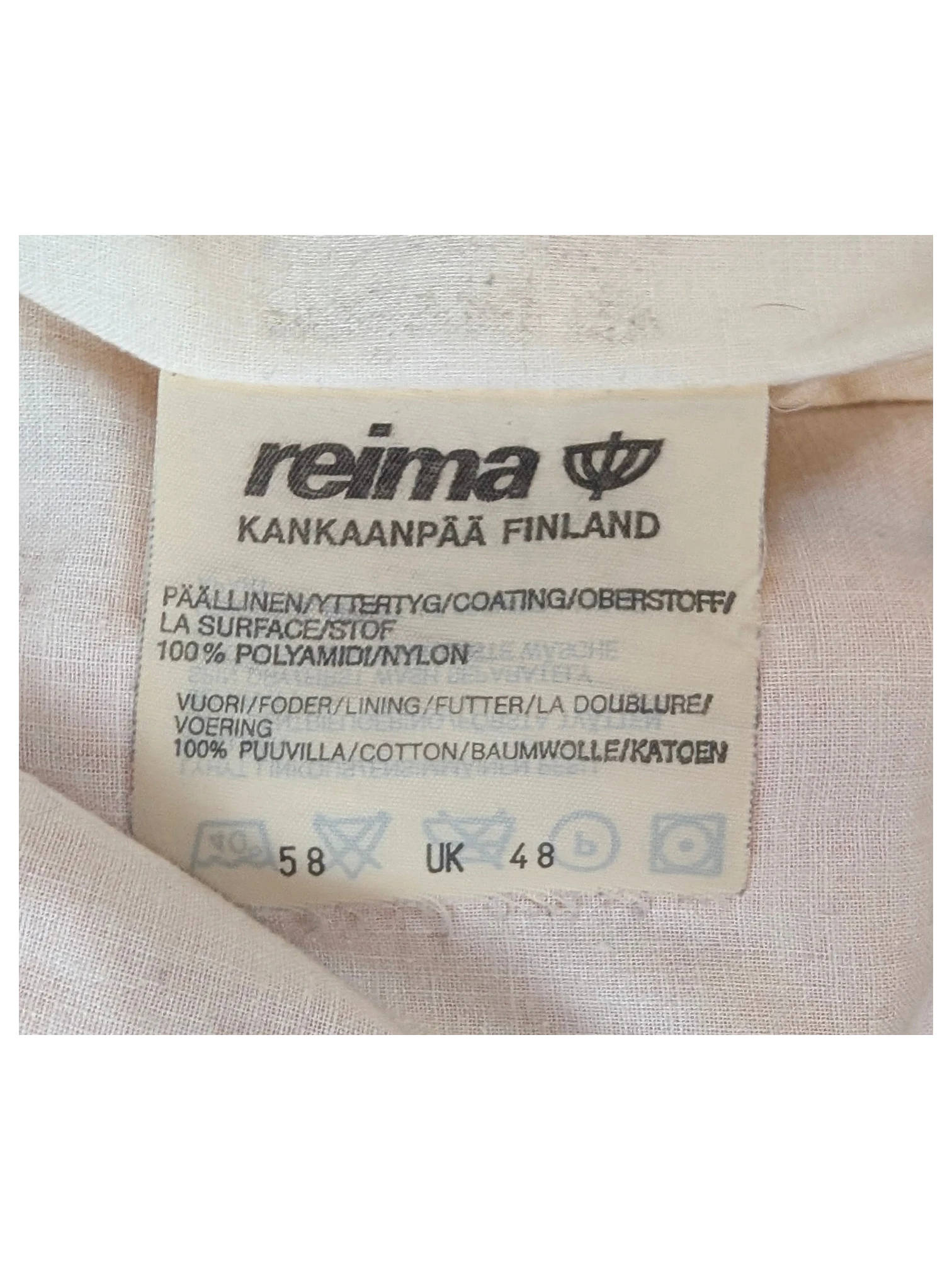 JAKE & IPI Reima clothing label showing 100% nylon outer and 100% cotton lining details