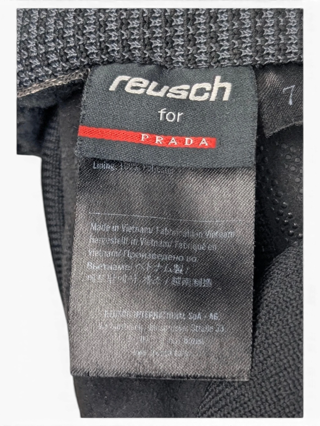 JAKE & IPI Reusch for Prada black technical gloves featuring a ribbed cuff and interior brand label detail