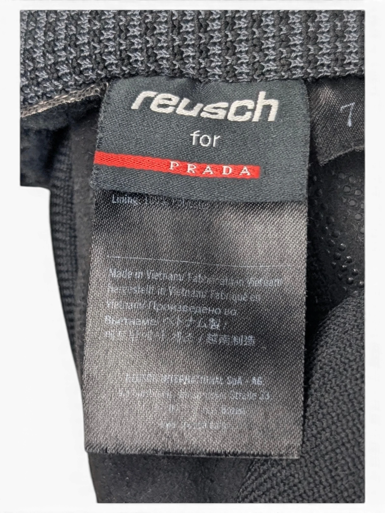JAKE & IPI Reusch for Prada black technical gloves featuring a ribbed cuff and interior brand label detail