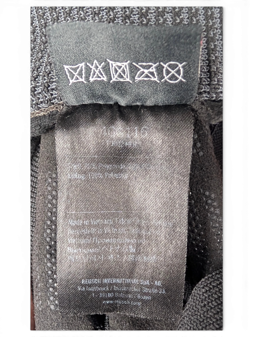 JAKE & IPI Reusch for Prada black glove care and material label showing polyester composition and washing symbols