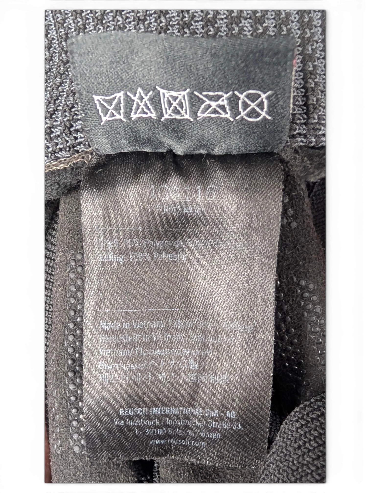 JAKE & IPI Reusch for Prada black glove care and material label showing polyester composition and washing symbols