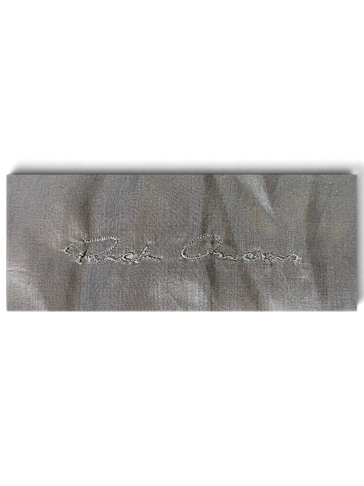 JAKE & IPI Rick Owens bomber jacket interior label with silver embroidered logo on grey fabric