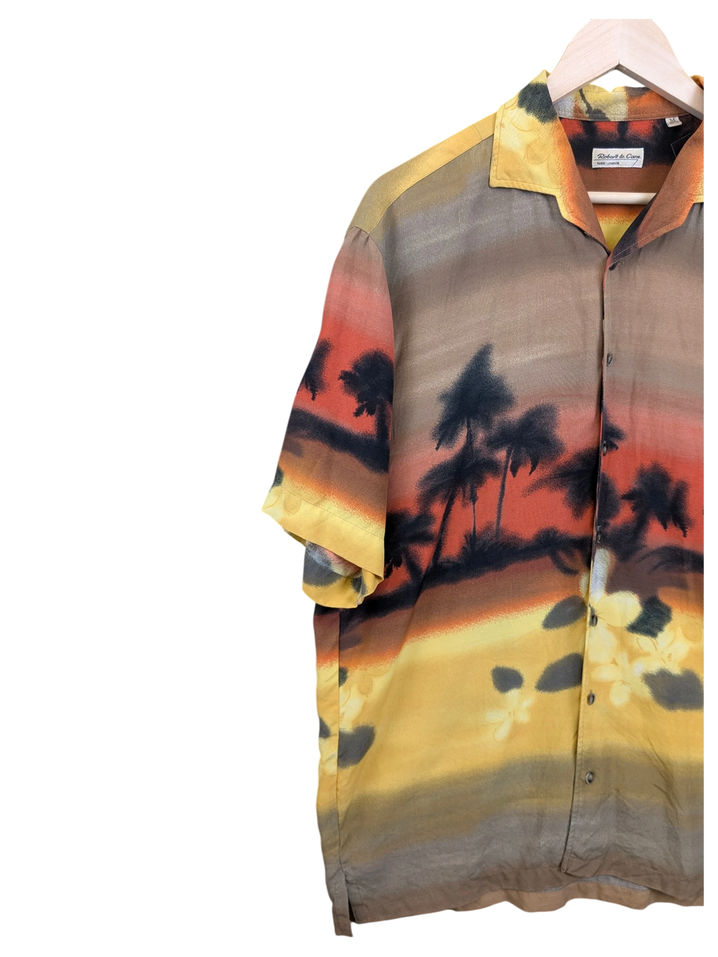 JAKE & IPI Robert Le Cam Hawaiian shirt featuring a sunset tropical palm tree landscape print in warm earth tones.