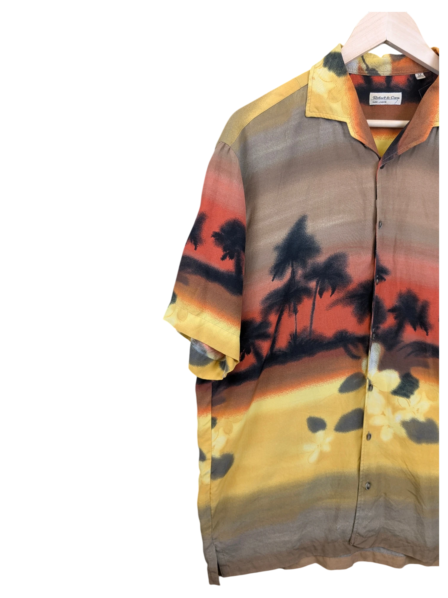 JAKE & IPI Robert Le Cam Hawaiian shirt featuring a sunset tropical palm tree landscape print in warm earth tones.