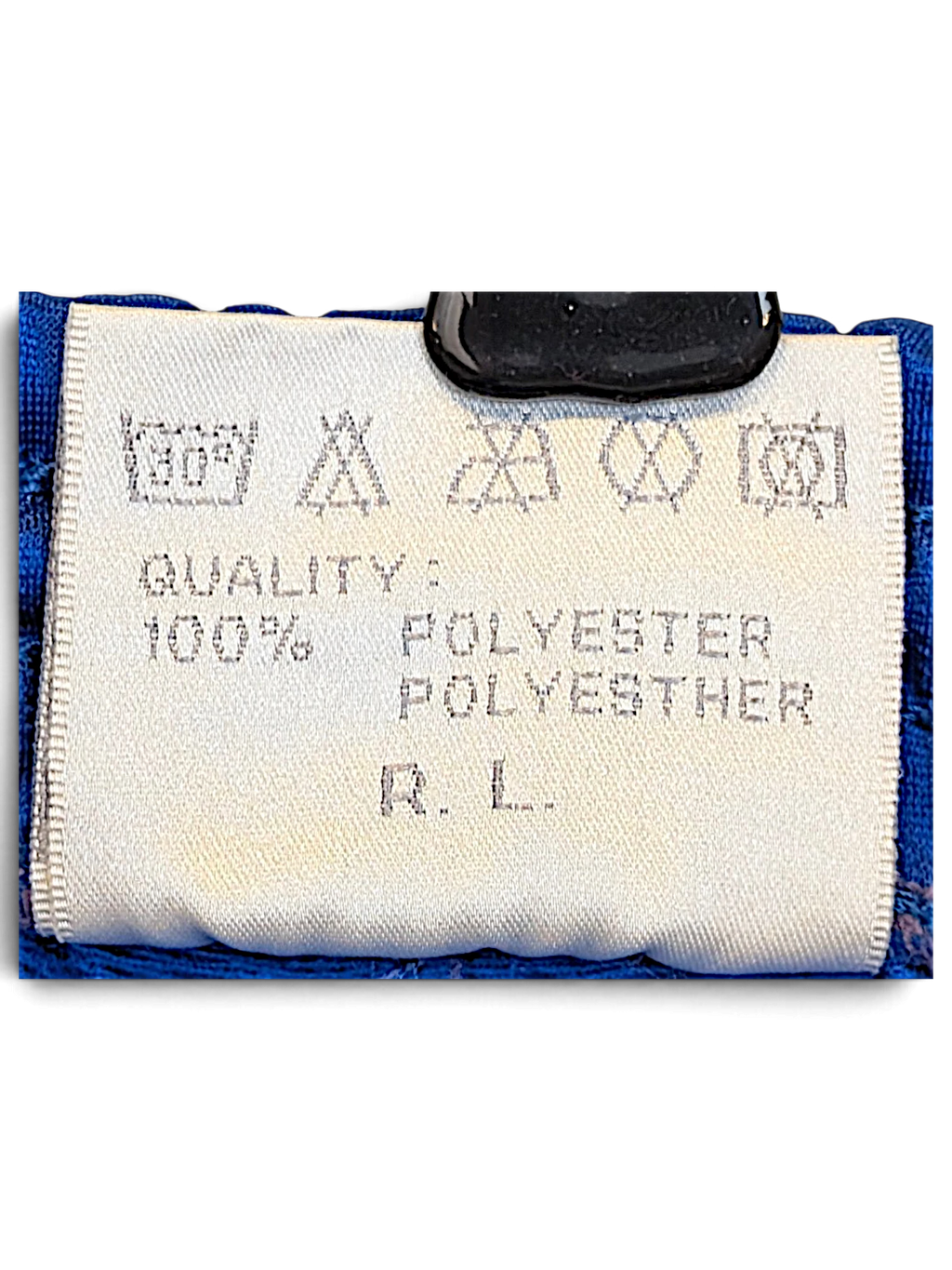 JAKE & IPI Rucanor track pants care label showing 100% polyester composition and laundry instructions
