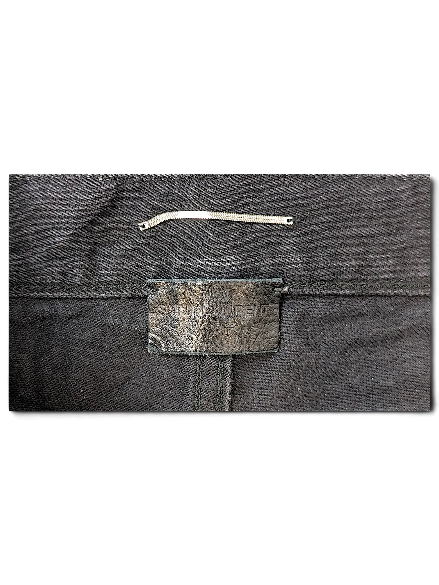 JAKE & IPI Saint Laurent black denim jeans featuring a leather brand patch on the back waistband