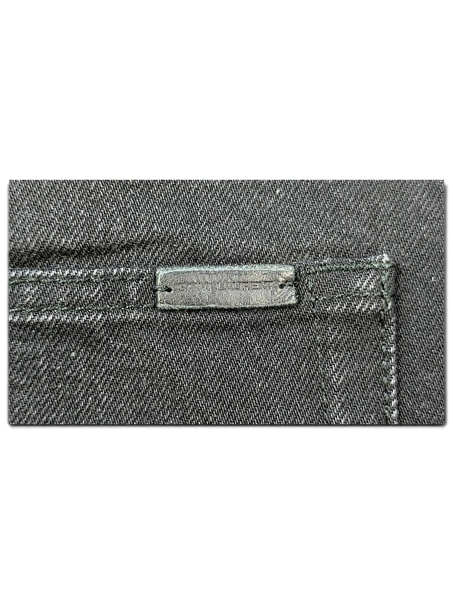 JAKE & IPI Saint Laurent black denim jeans featuring a branded leather patch on the back pocket