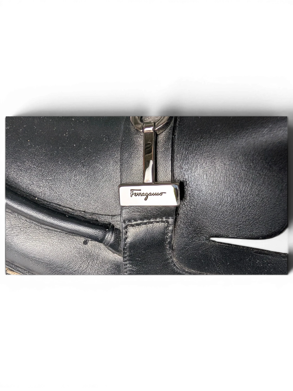 JAKE & IPI black leather Salvatore Ferragamo loafers featuring silver-tone metal hardware detail on the upper.