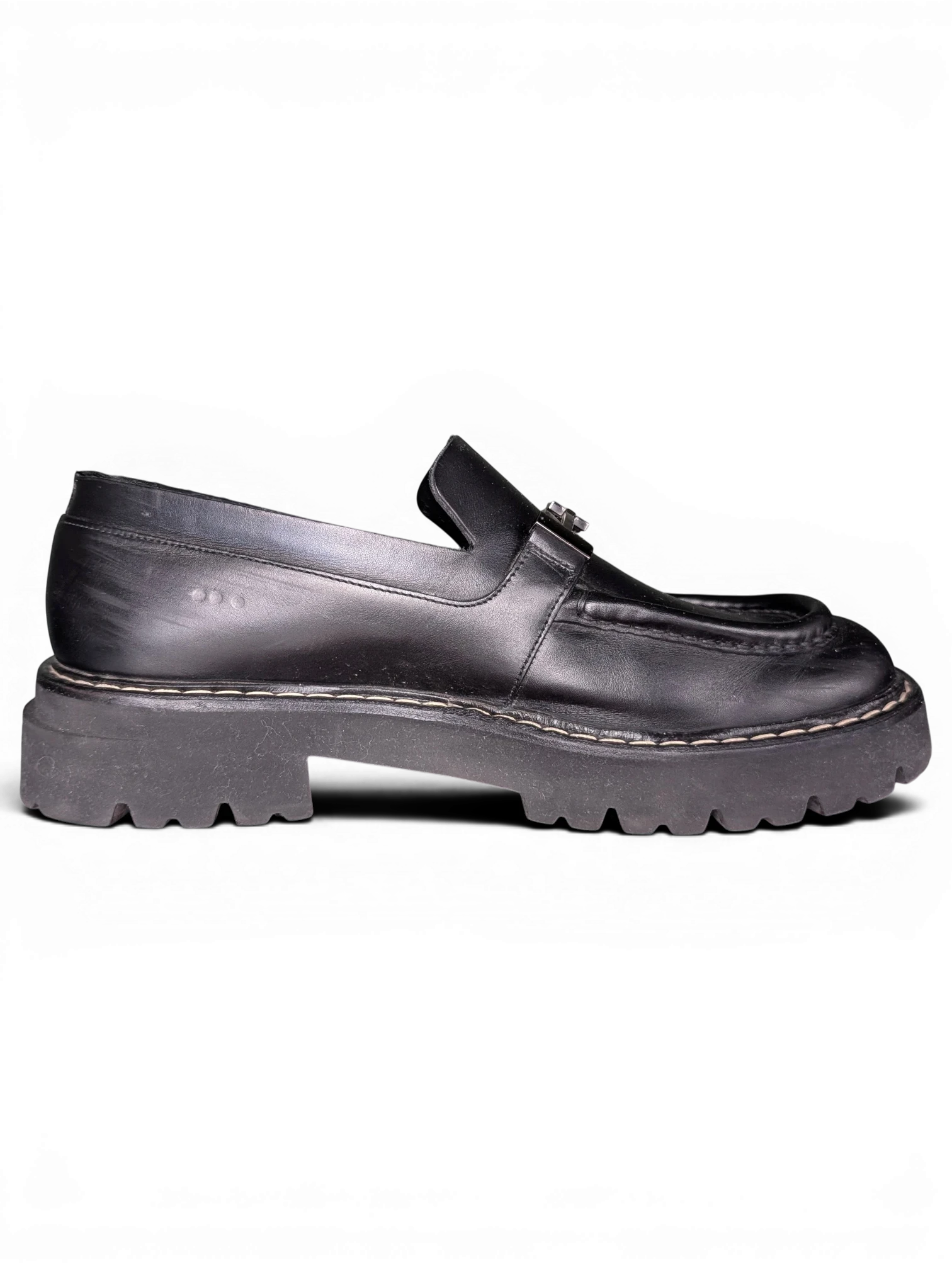 JAKE & IPI black leather Salvatore Ferragamo loafers featuring metal hardware and a chunky lug rubber sole.