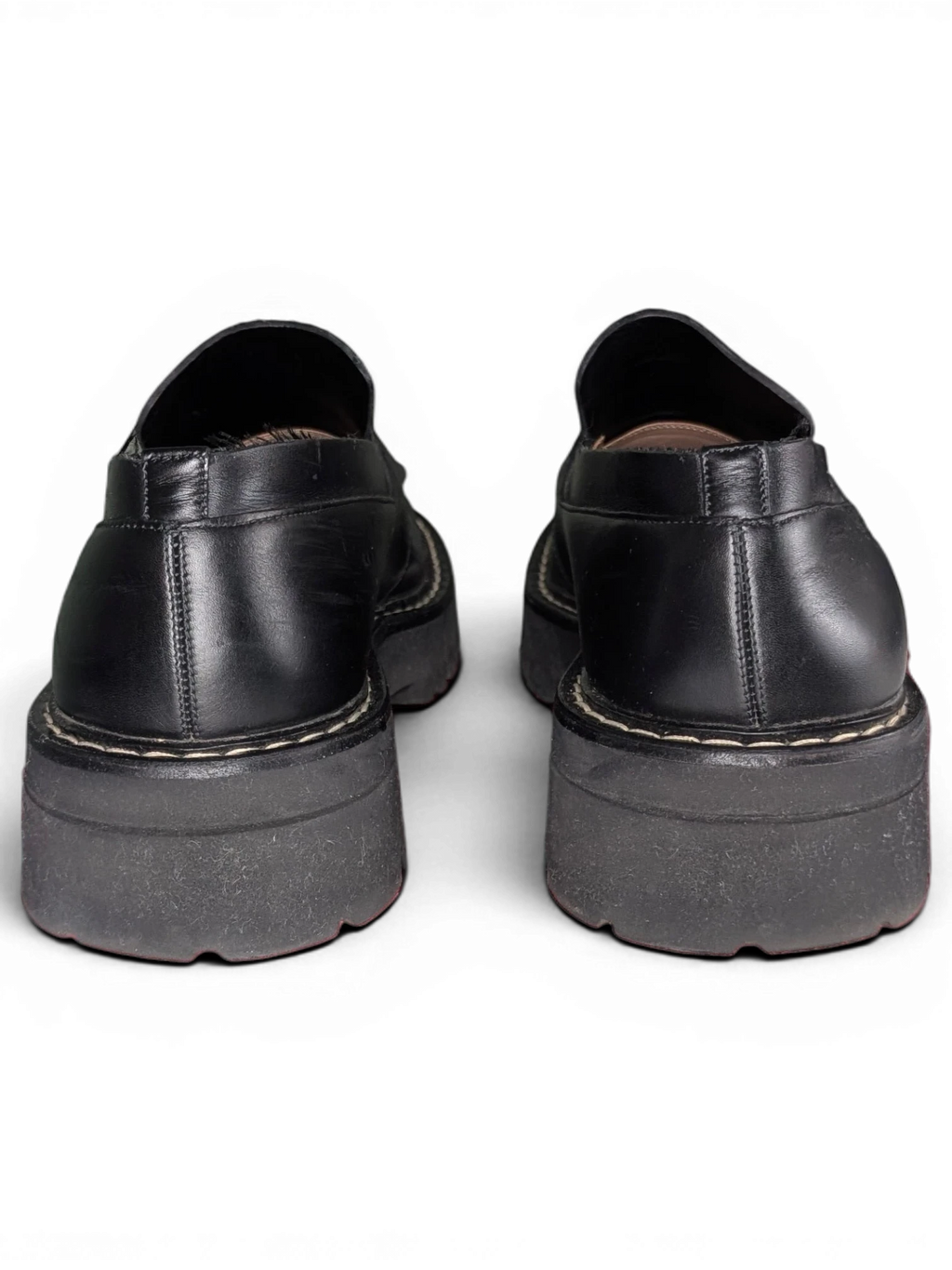 Back view of black leather Salvatore Ferragamo loafers with chunky rubber soles from JAKE & IPI