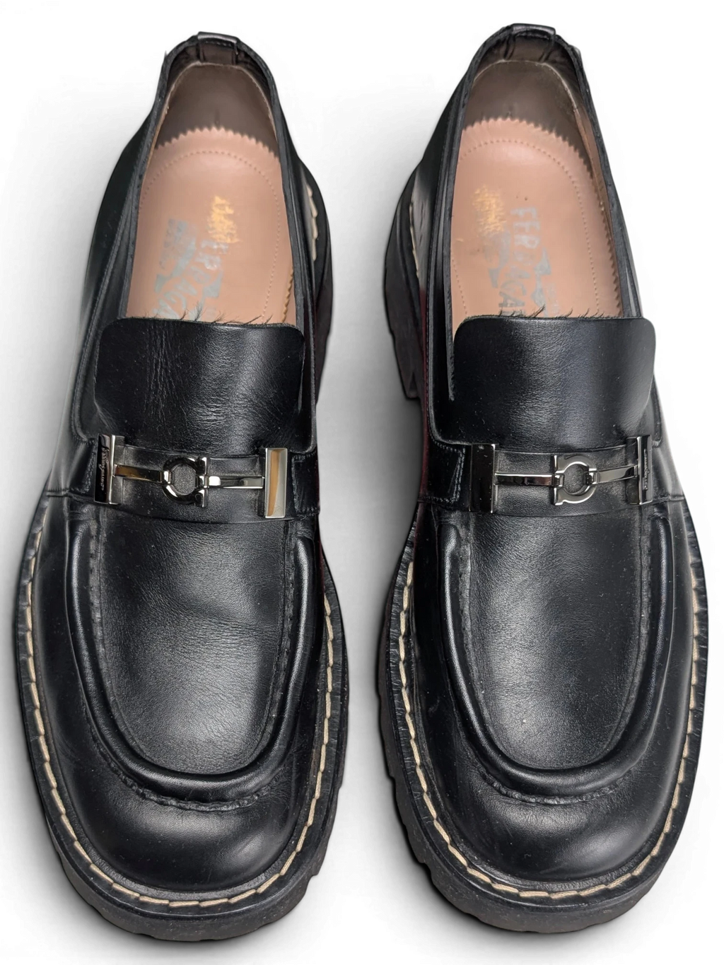 JAKE & IPI black leather Salvatore Ferragamo loafers featuring silver metal hardware and a chunky rubber sole.