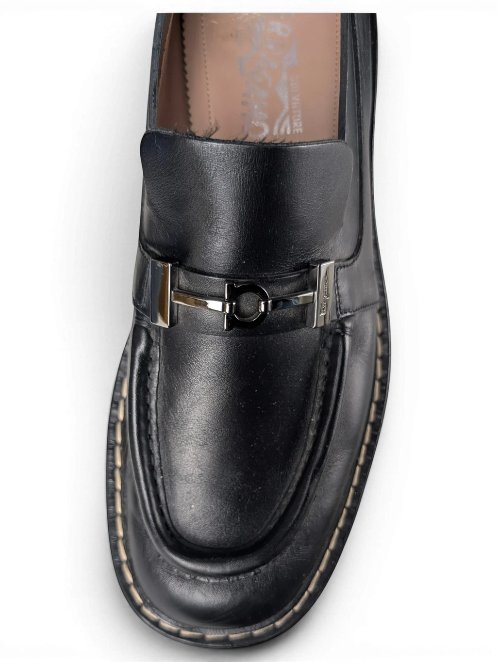 JAKE & IPI black leather Salvatore Ferragamo loafers featuring silver metal hardware and a chunky rubber sole.