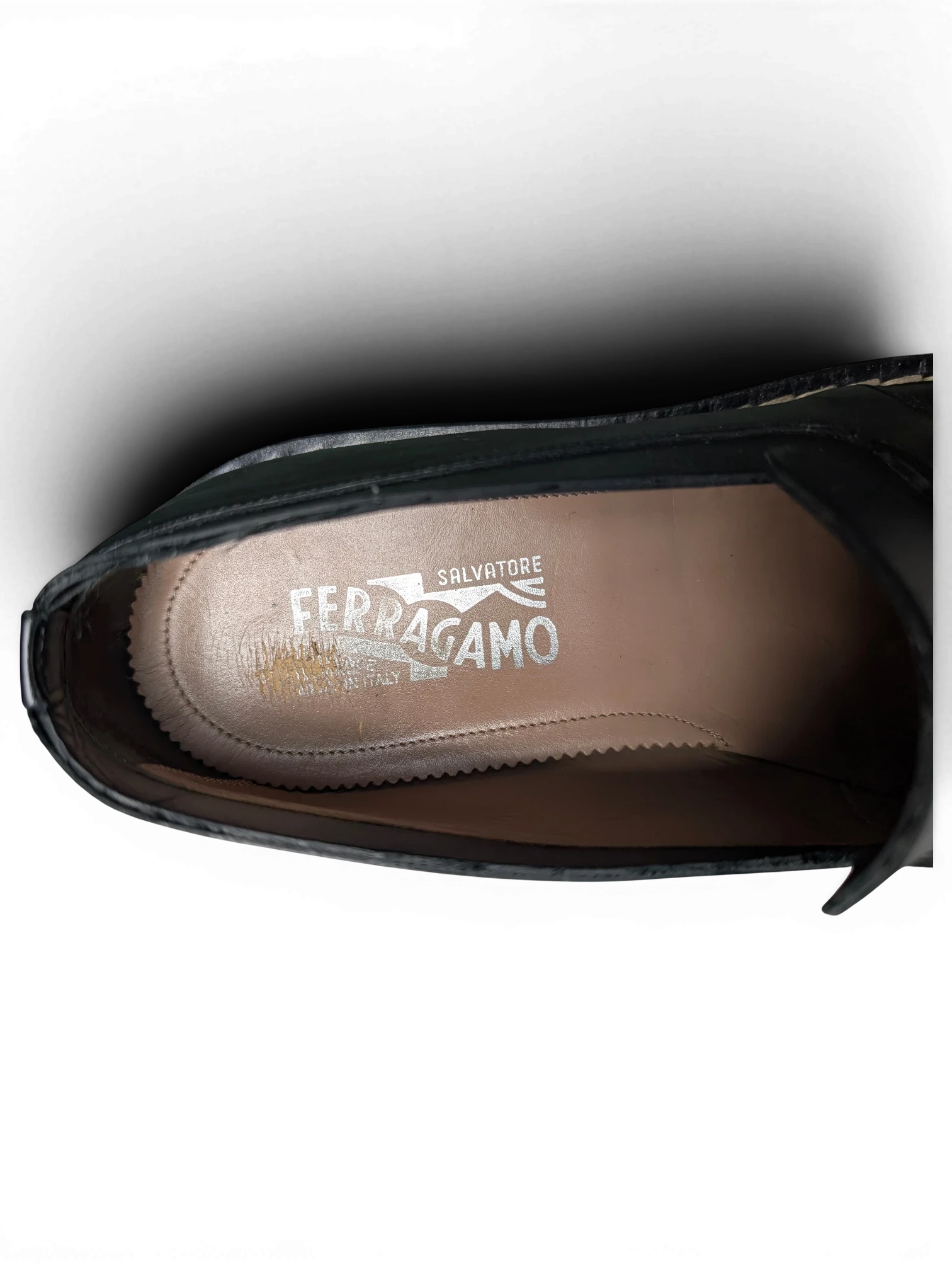 Interior view of JAKE & IPI Salvatore Ferragamo loafers featuring the brand logo on the tan leather insole