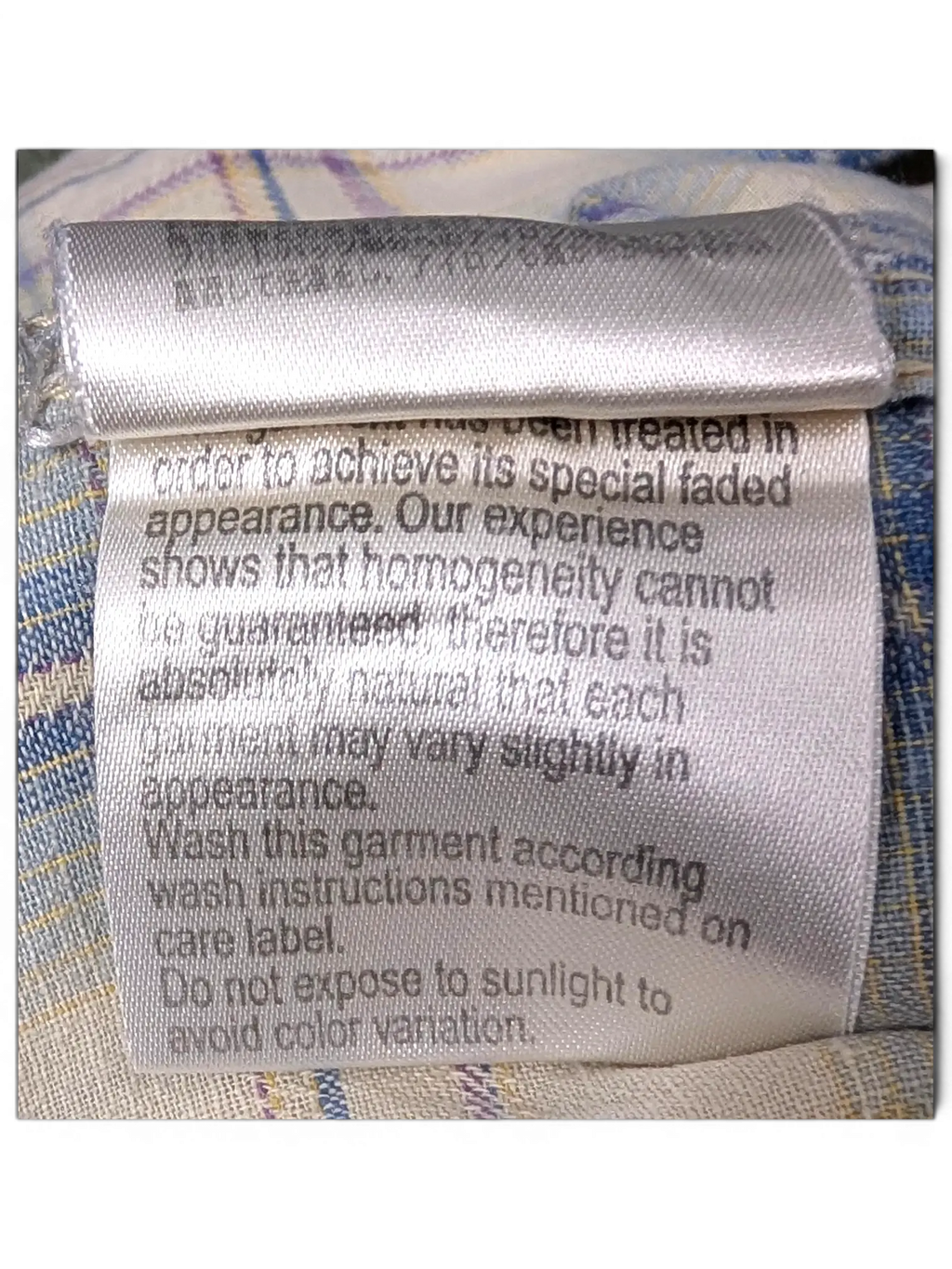 JAKE & IPI Scotch & Soda plaid shirt care label with faded appearance instructions on beige, blue, and burgundy fabric
