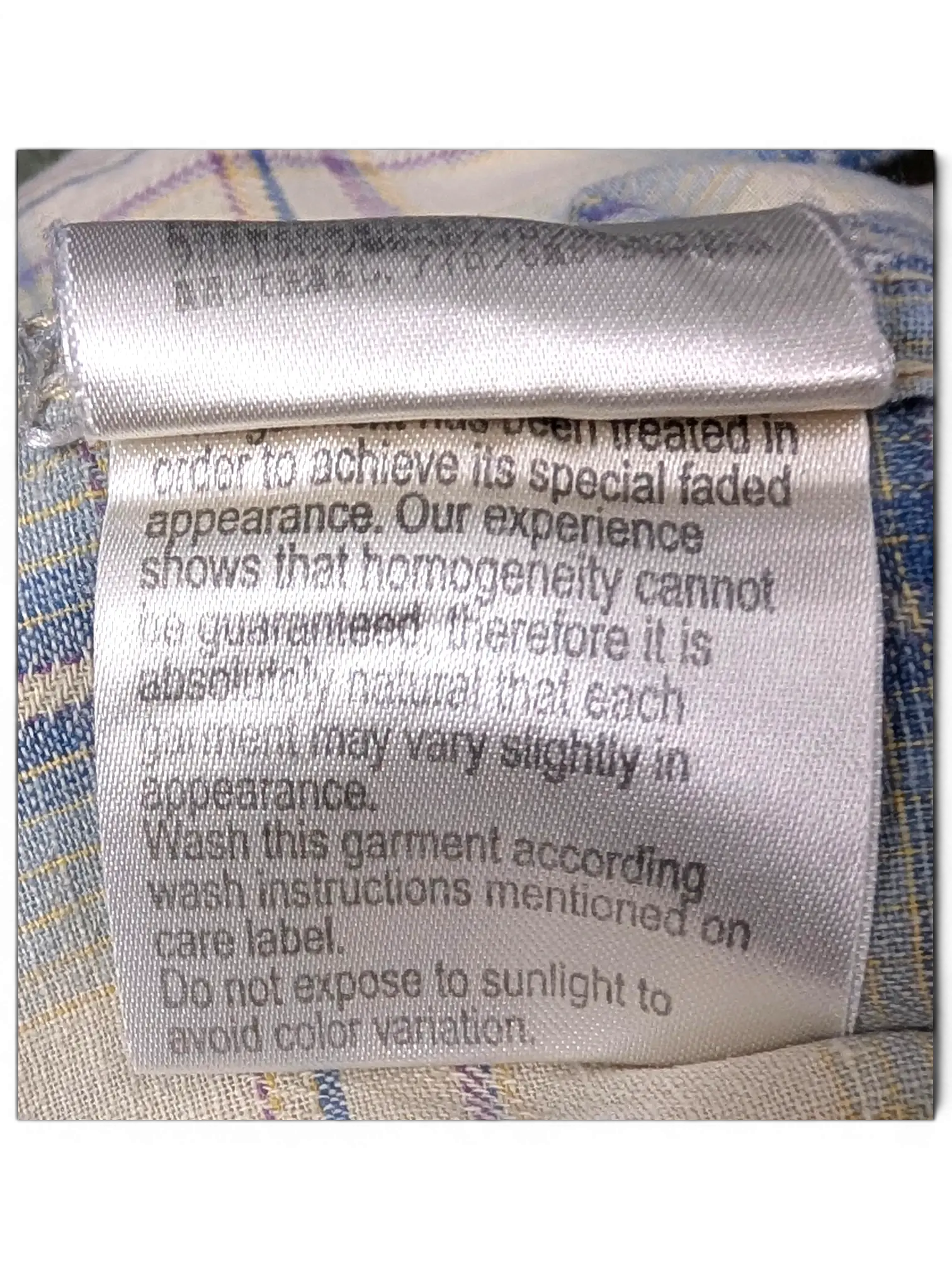 JAKE & IPI Scotch & Soda plaid shirt care label with faded appearance instructions on beige, blue, and burgundy fabric