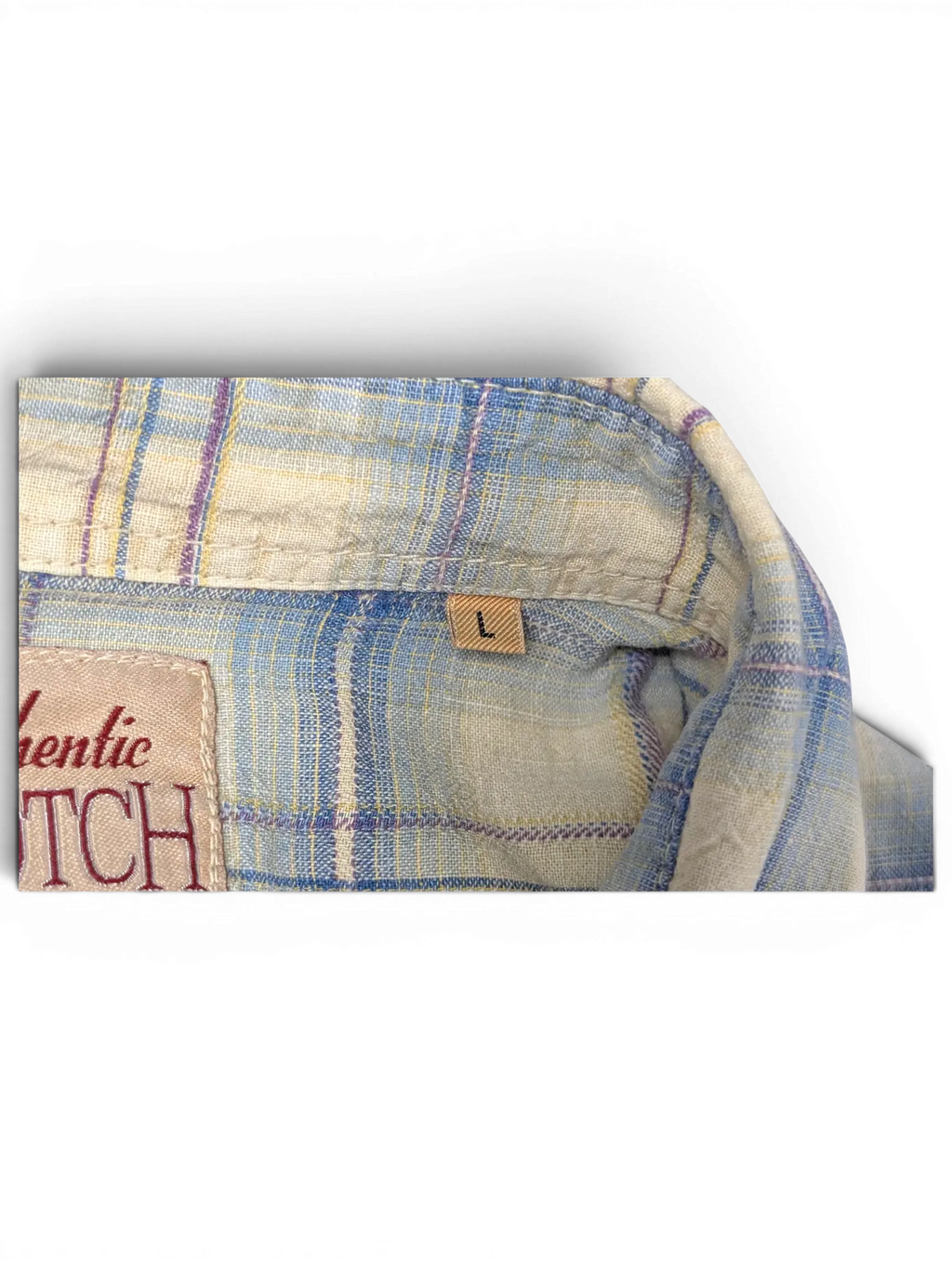 JAKE & IPI Scotch & Soda plaid shirt collar detail showing size L label in beige, blue, and burgundy tones