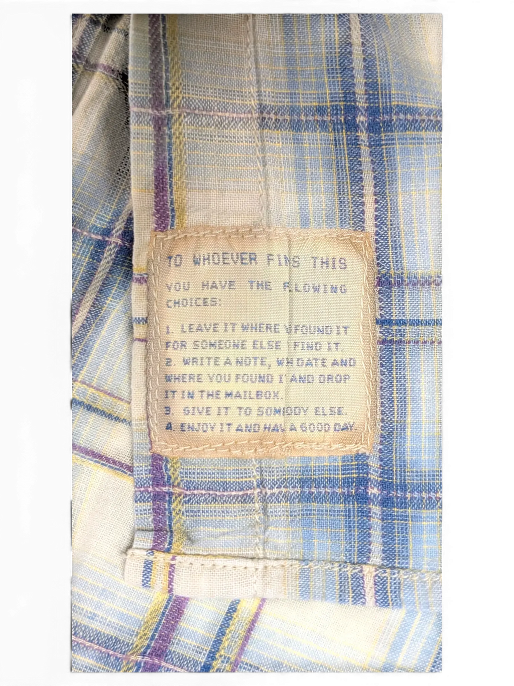JAKE & IPI Scotch & Soda plaid shirt featuring a unique internal message patch on beige, blue, and burgundy fabric.