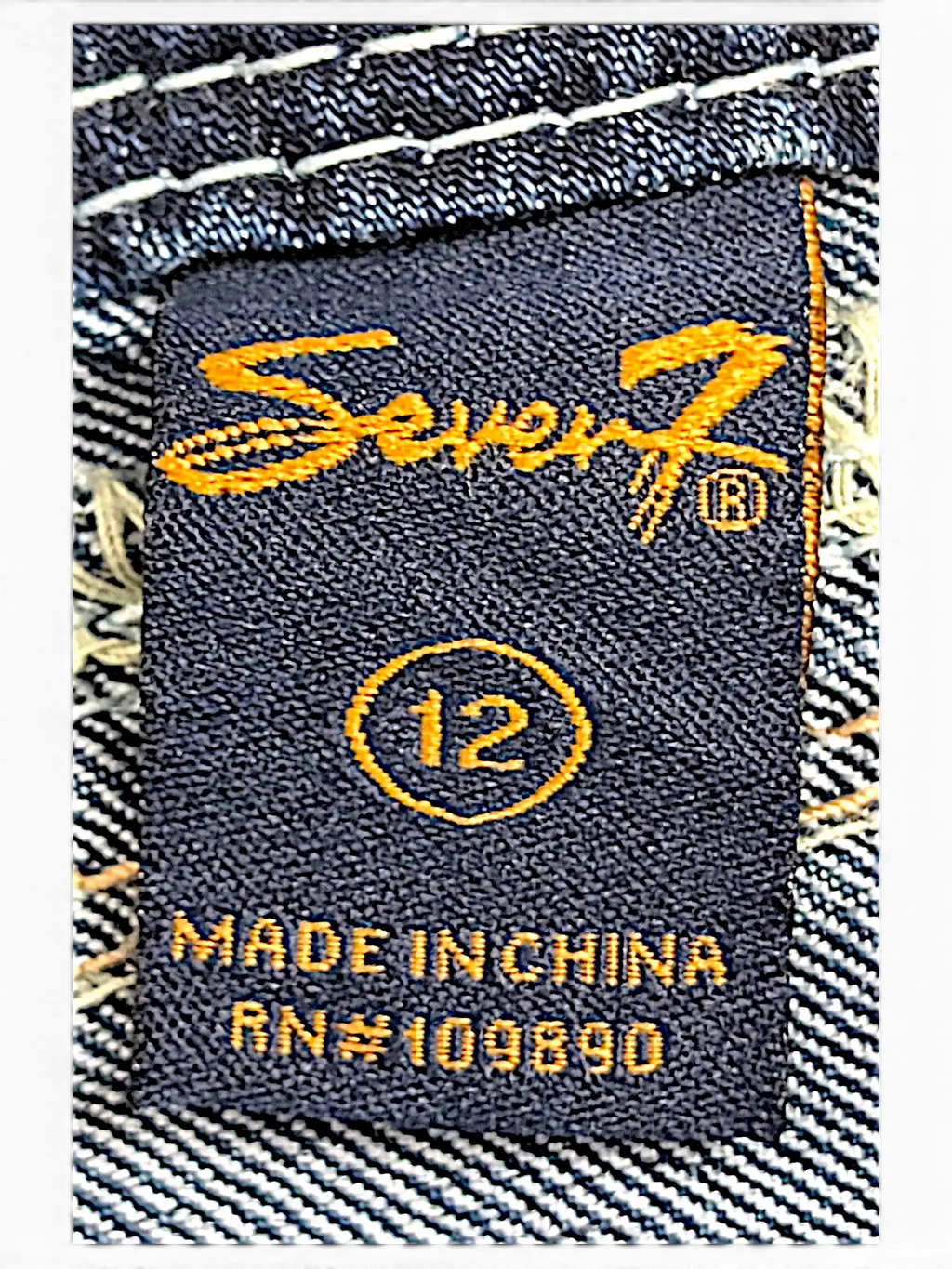 JAKE & IPI Seven7 capri jeans size 12 label with orange embroidery on dark blue denim fabric