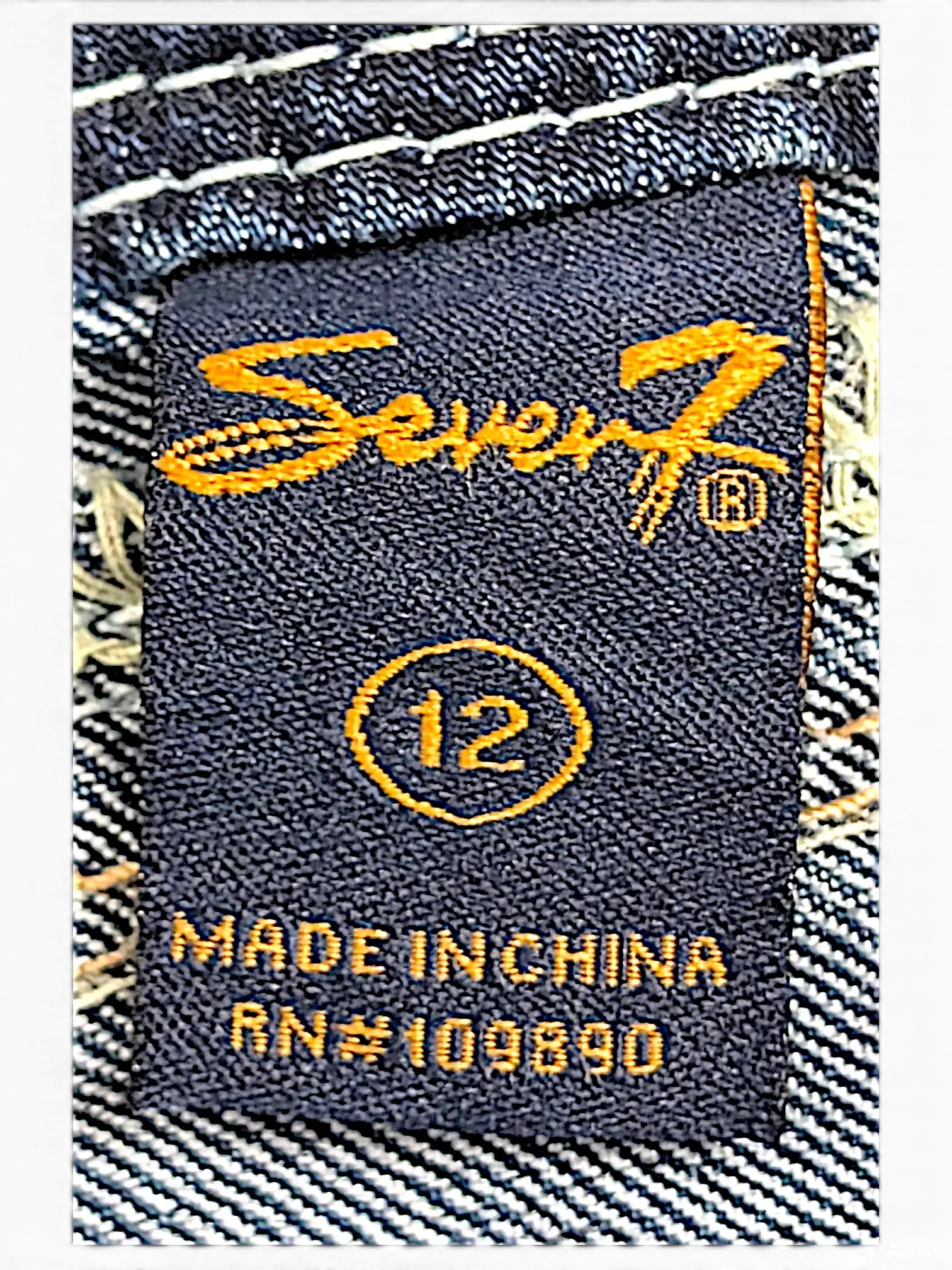JAKE & IPI Seven7 capri jeans size 12 label with orange embroidery on dark blue denim fabric