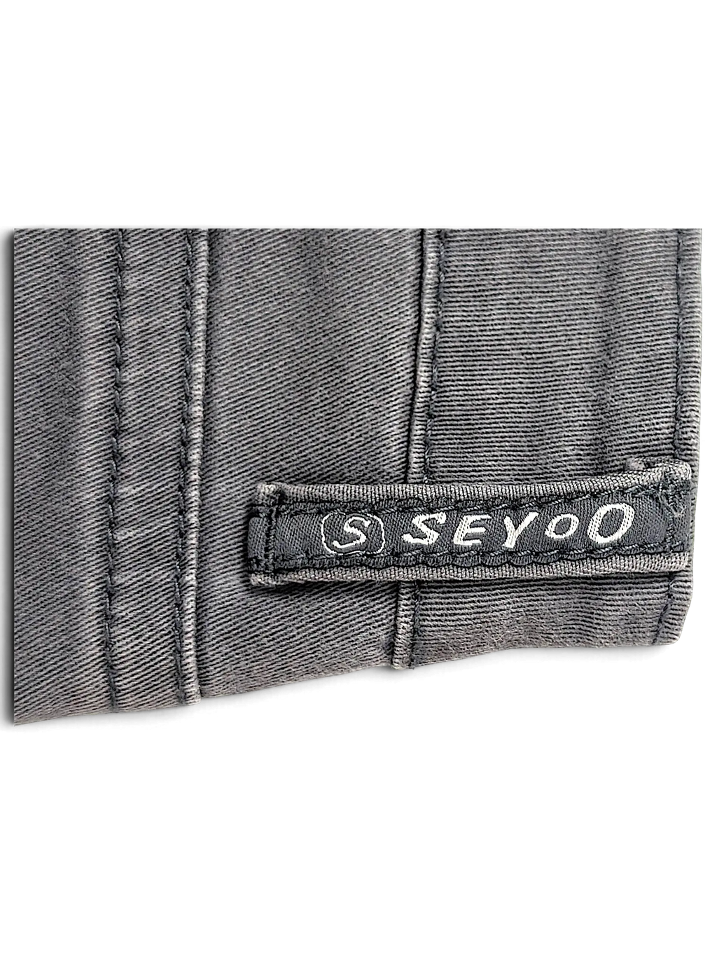 JAKE & IPI Seyoo Denim Division Y2K jeans featuring a grey fabric texture and a branded logo patch detail.