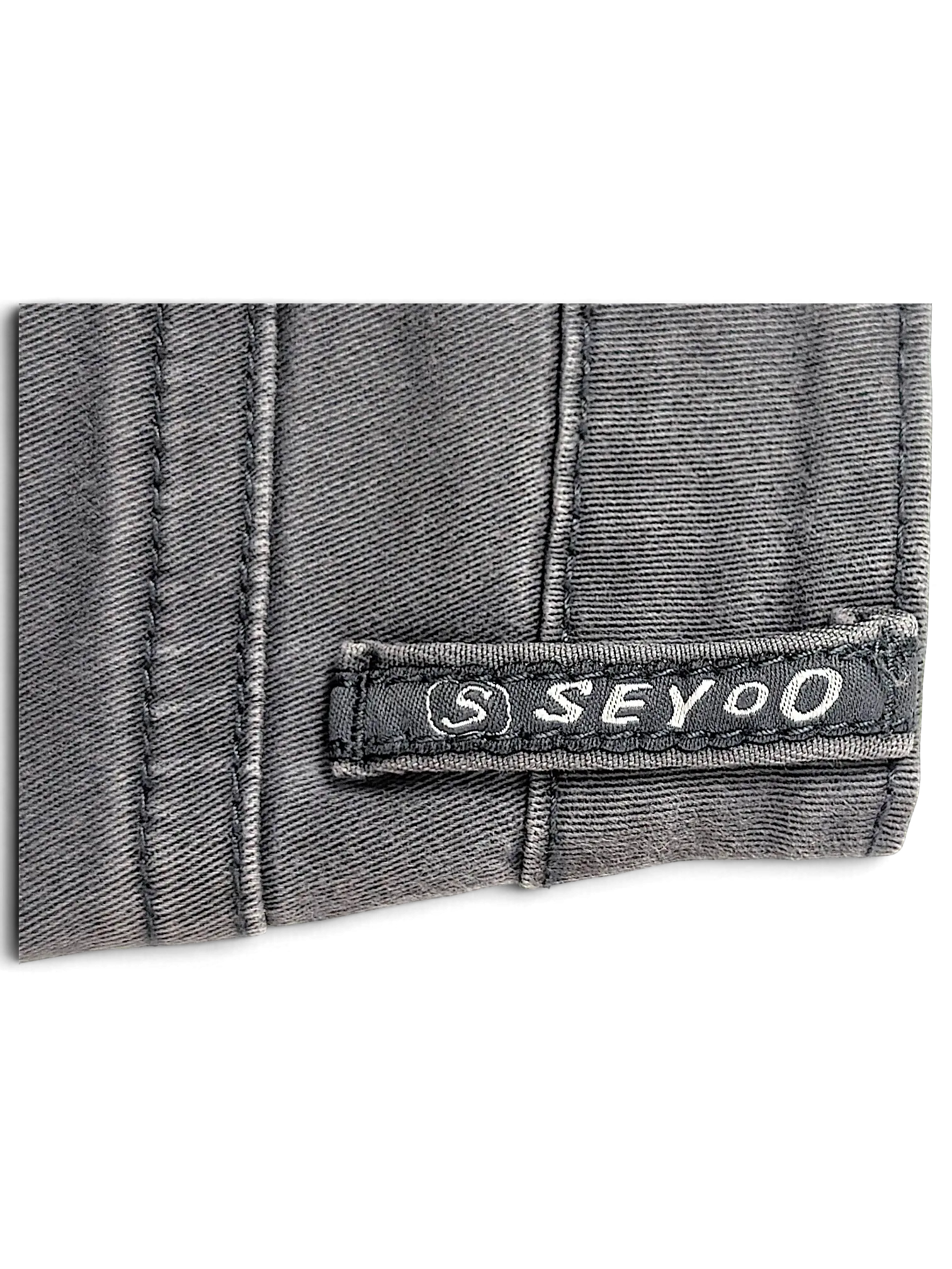 JAKE & IPI Seyoo Denim Division Y2K jeans featuring a grey fabric texture and a branded logo patch detail.
