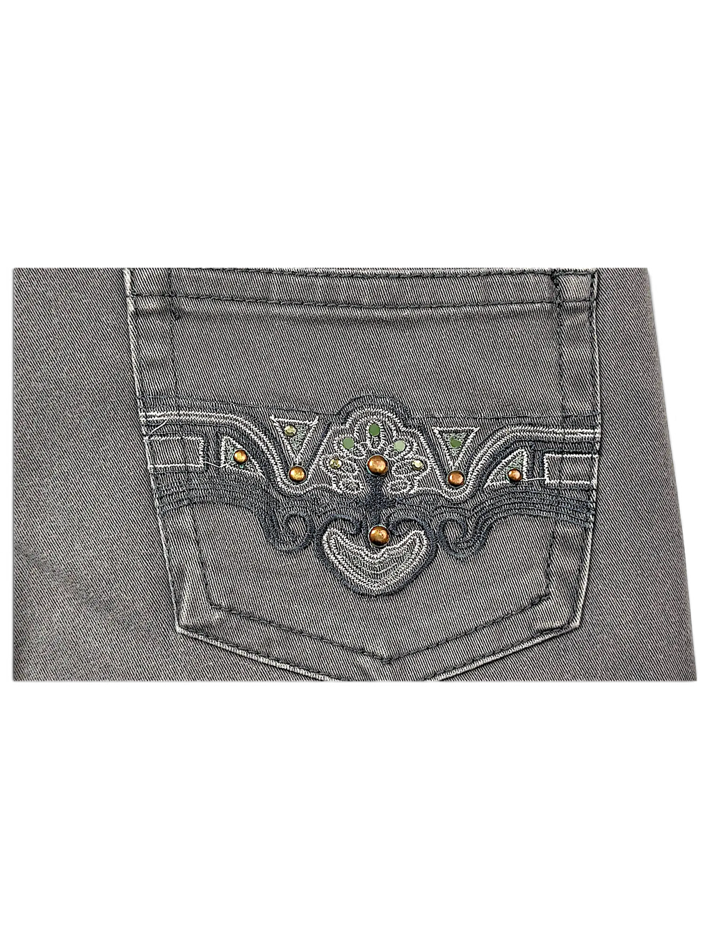 JAKE & IPI Seyoo Denim Division Y2K jeans back pocket featuring intricate dark embroidery, studs, and green accents.