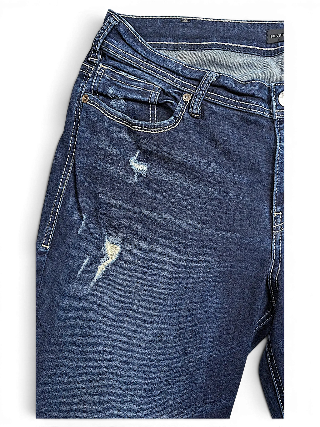 JAKE & IPI Silver Jeans Co. Suki Capri in dark wash denim with distressed detailing and contrast stitching