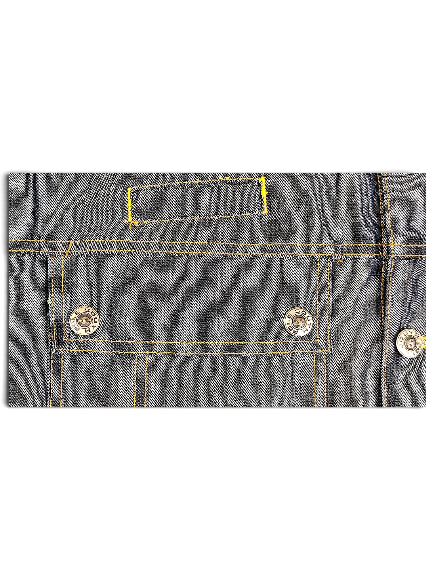 Close-up of a JAKE & IPI Southpole denim jacket featuring dark blue fabric, yellow stitching, and branded metal buttons.