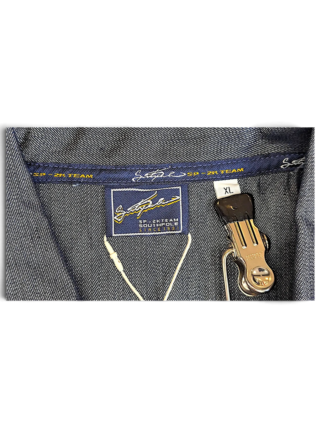 JAKE & IPI Southpole denim jacket interior label showing SP-2K Team branding and size XL tag