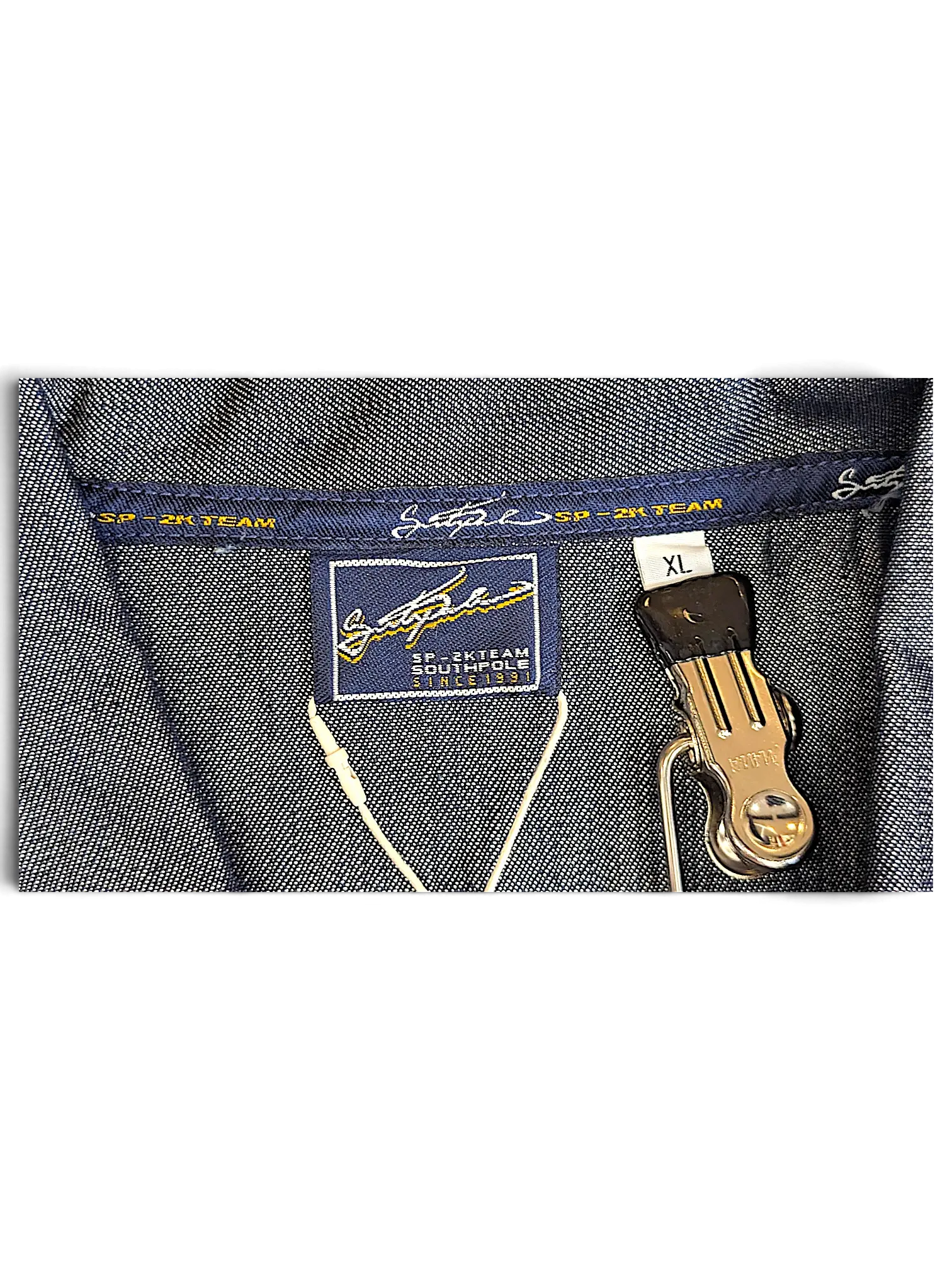 JAKE & IPI Southpole denim jacket interior label showing SP-2K Team branding and size XL tag