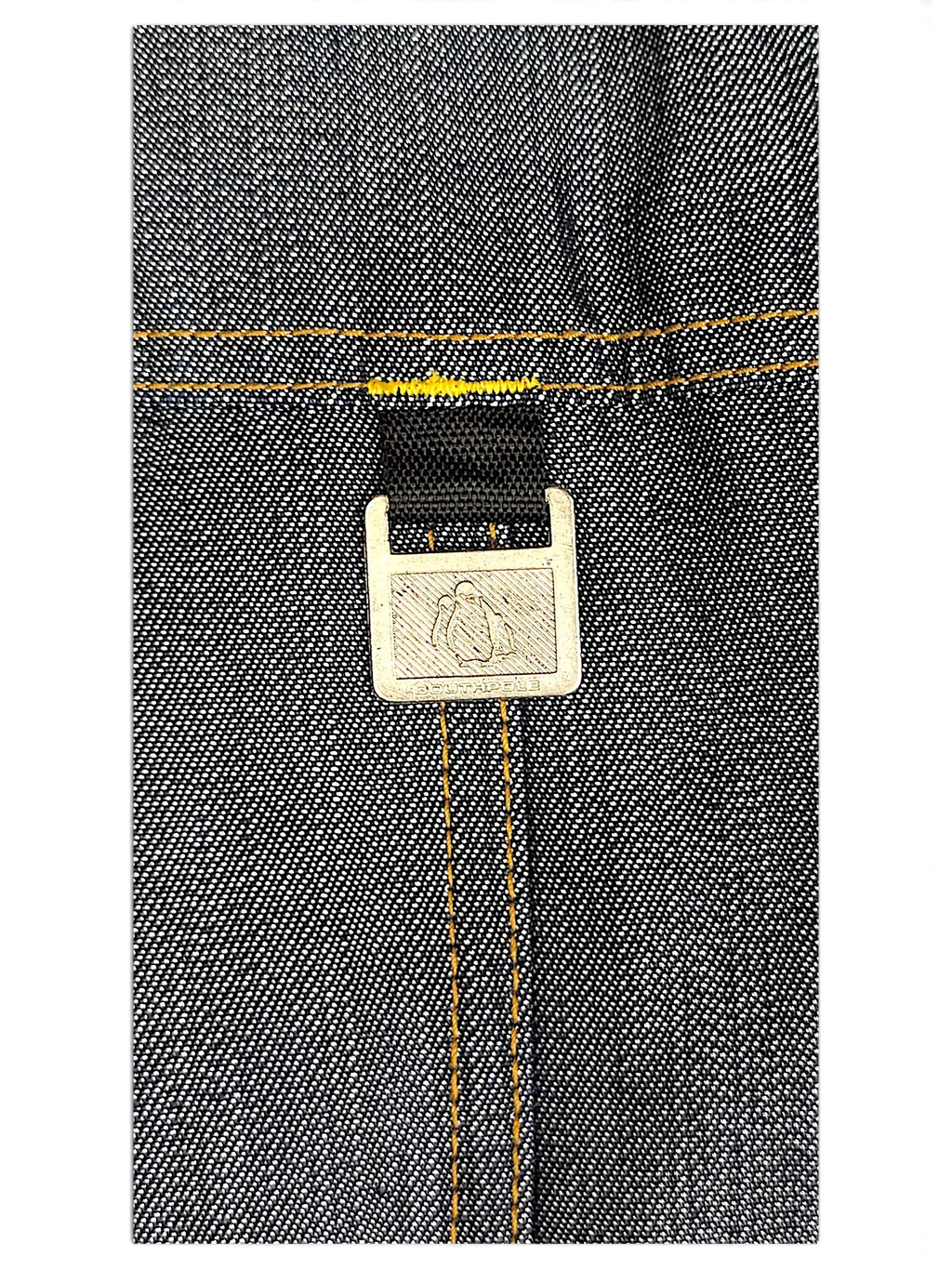 JAKE & IPI Southpole dark denim jacket detail featuring a branded metal hardware tag with contrast yellow stitching.