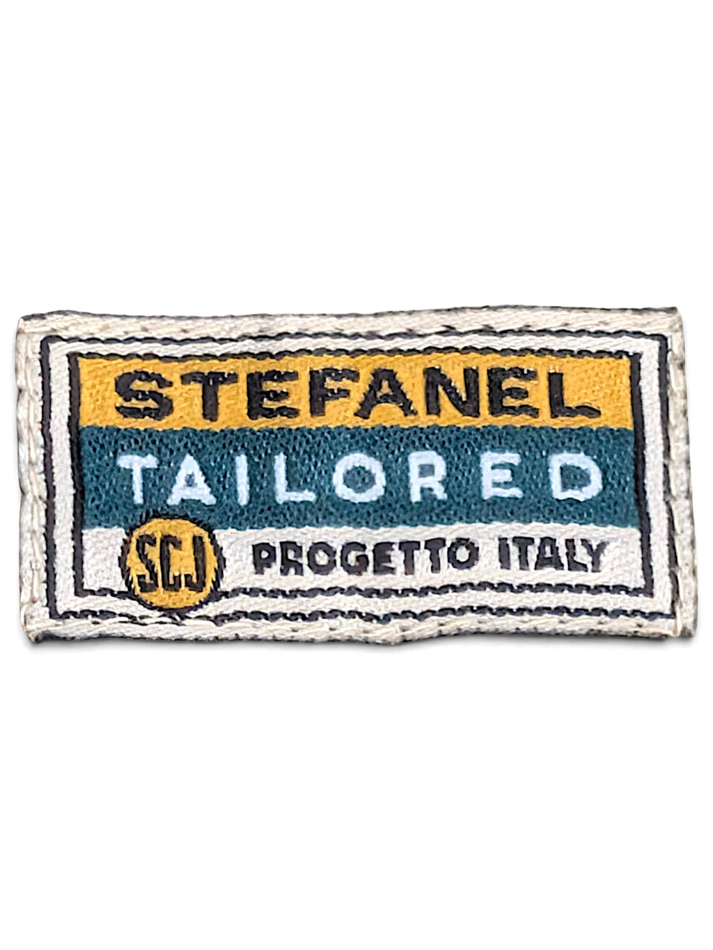JAKE & IPI Stefanel Tailored Progetto Italy clothing label with yellow, teal, and white embroidered text
