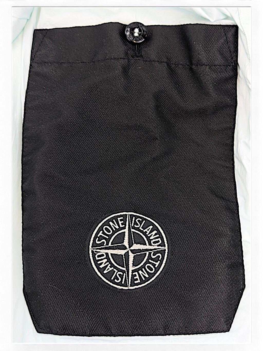 Stone Island down coat interior with snap pocket and embroidered detail