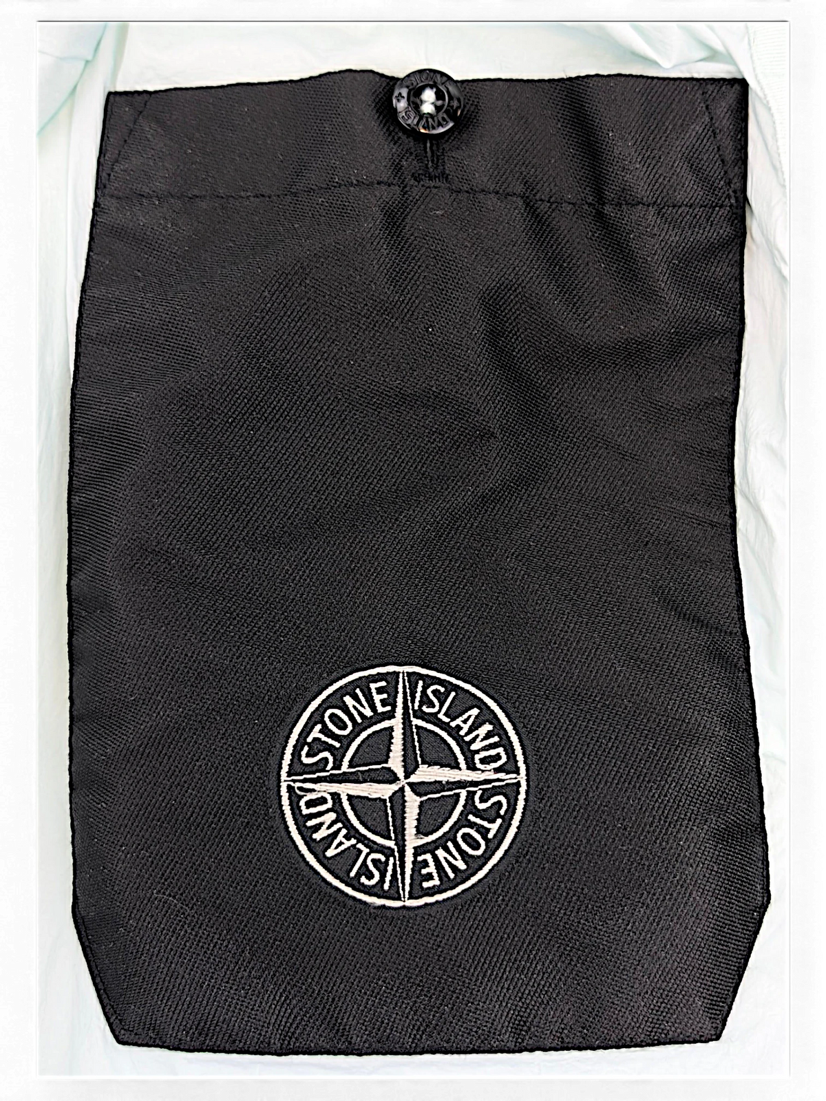 Stone Island down coat interior with snap pocket and embroidered detail