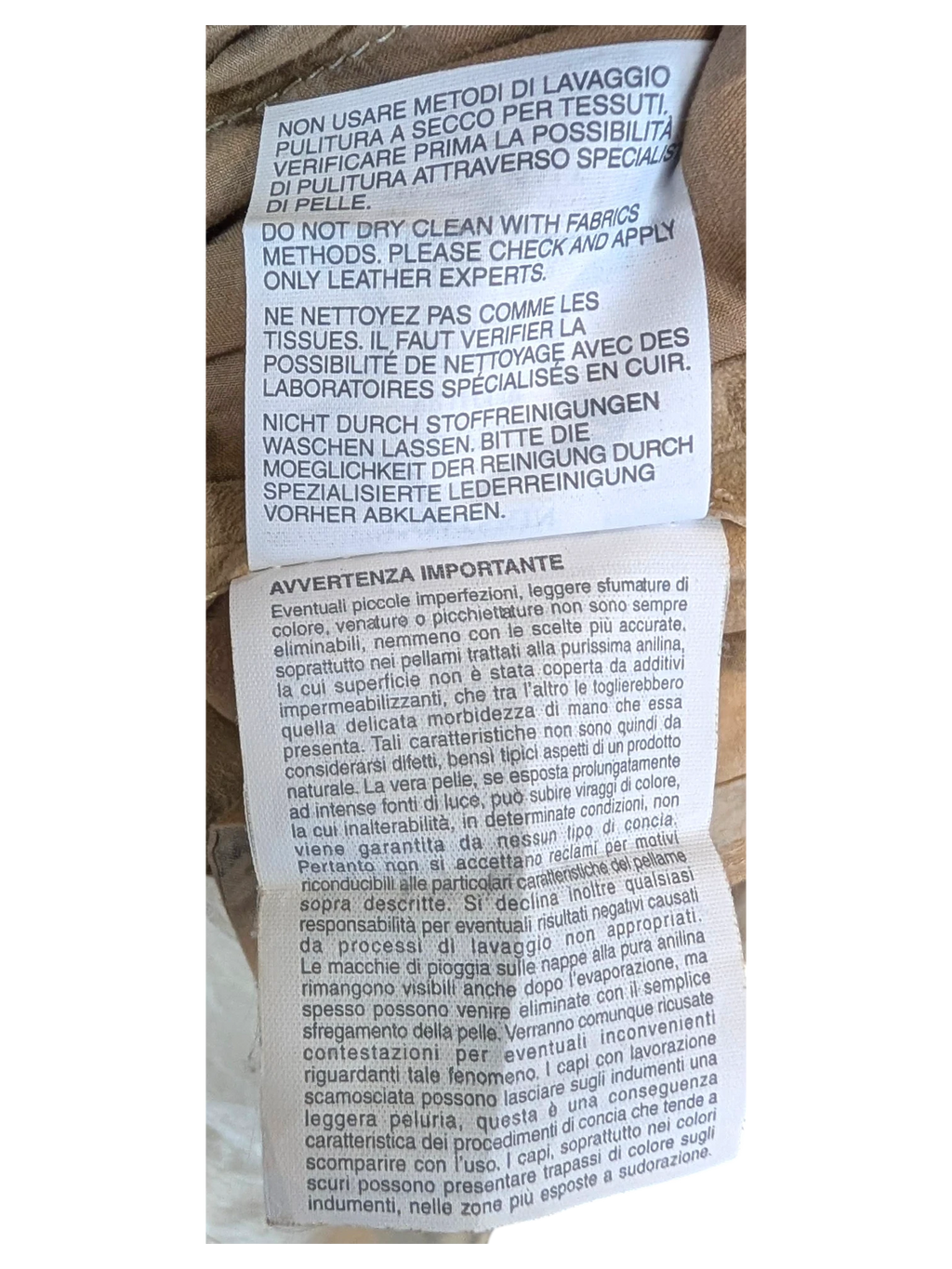 JAKE & IPI suede leather pants care instruction label with cleaning guidelines in multiple languages