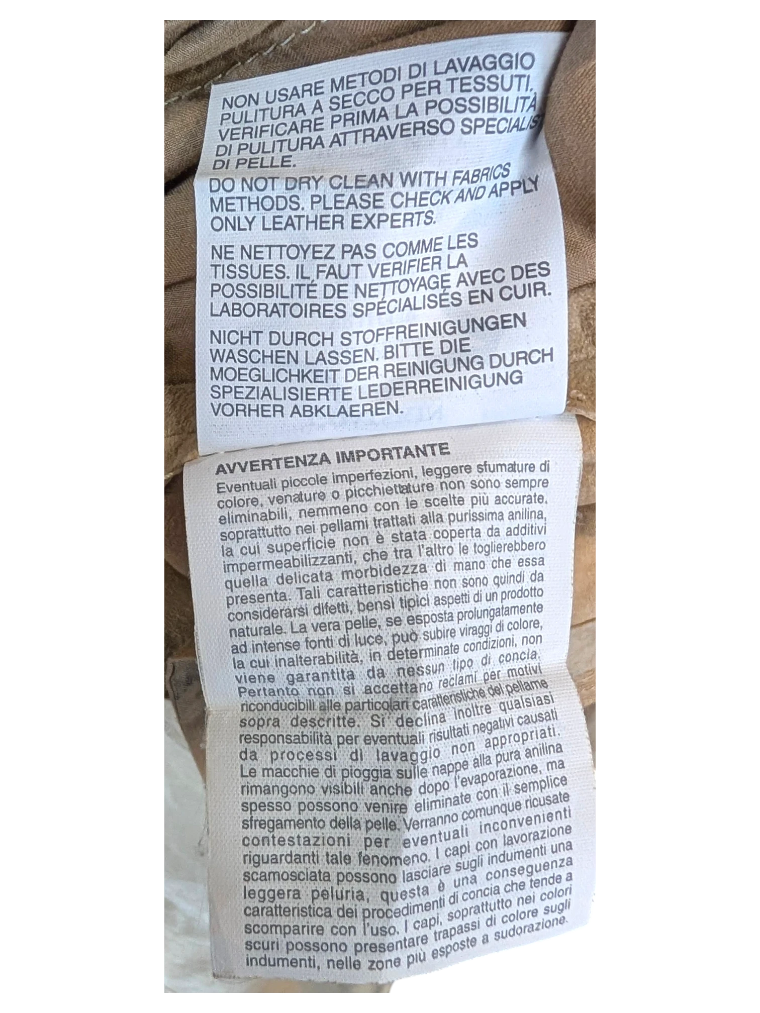 JAKE & IPI suede leather pants care instruction label with cleaning guidelines in multiple languages