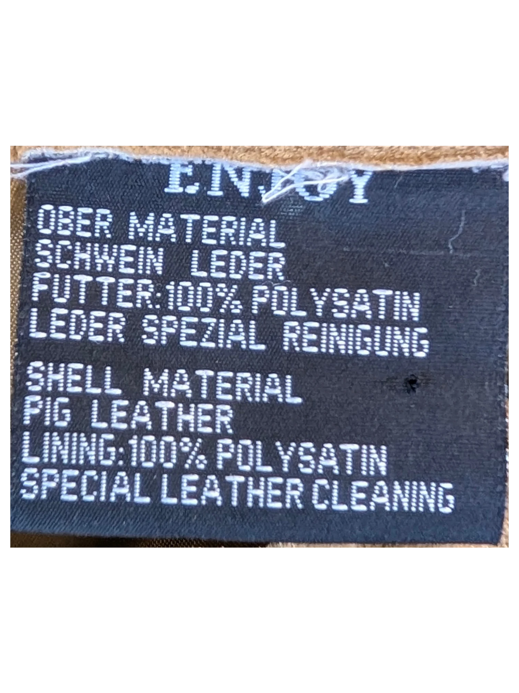JAKE & IPI Enjoy suede leather pants care label showing pig leather shell and polyester satin lining