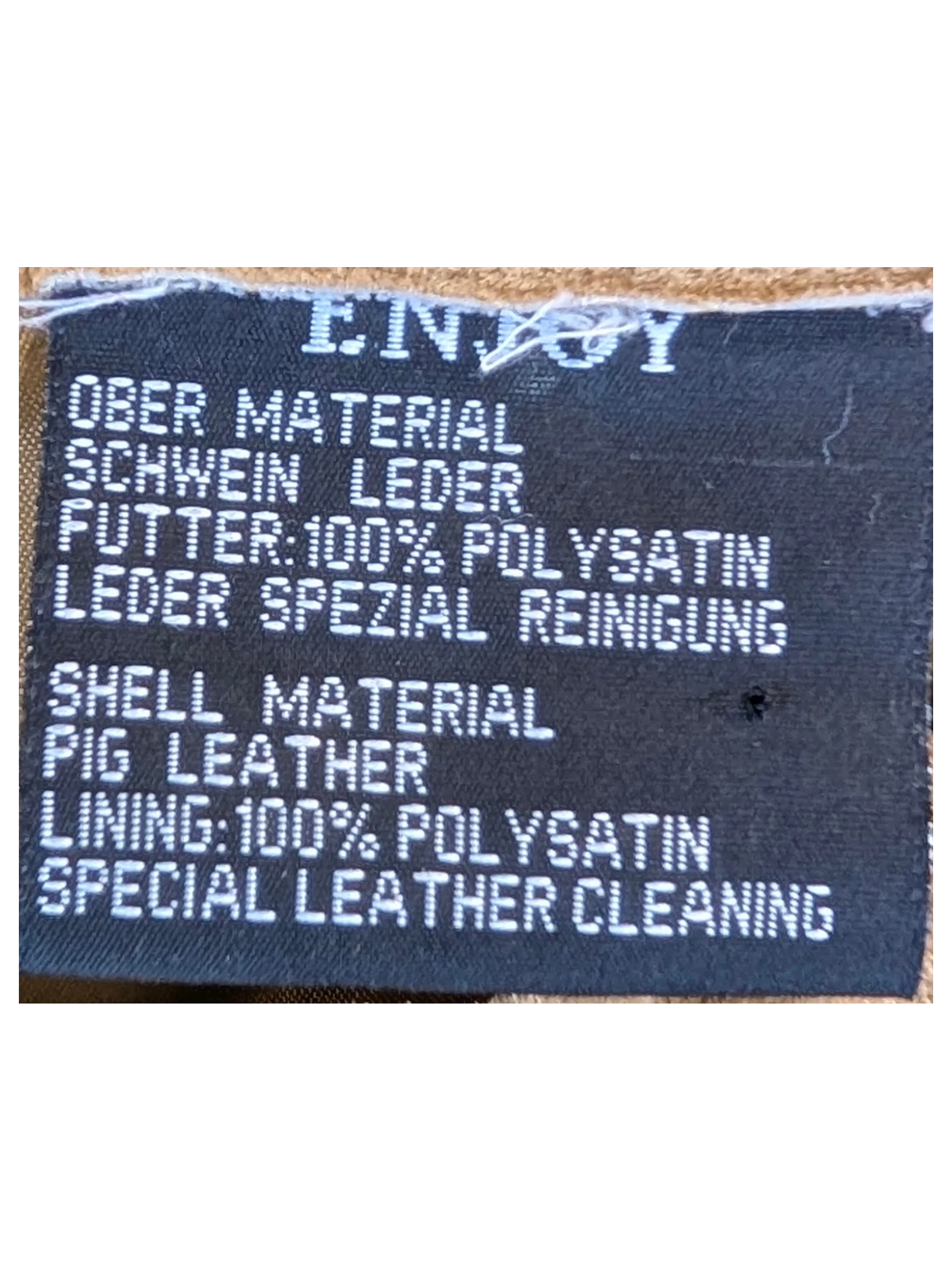 JAKE & IPI Enjoy suede leather pants care label showing pig leather shell and polyester satin lining