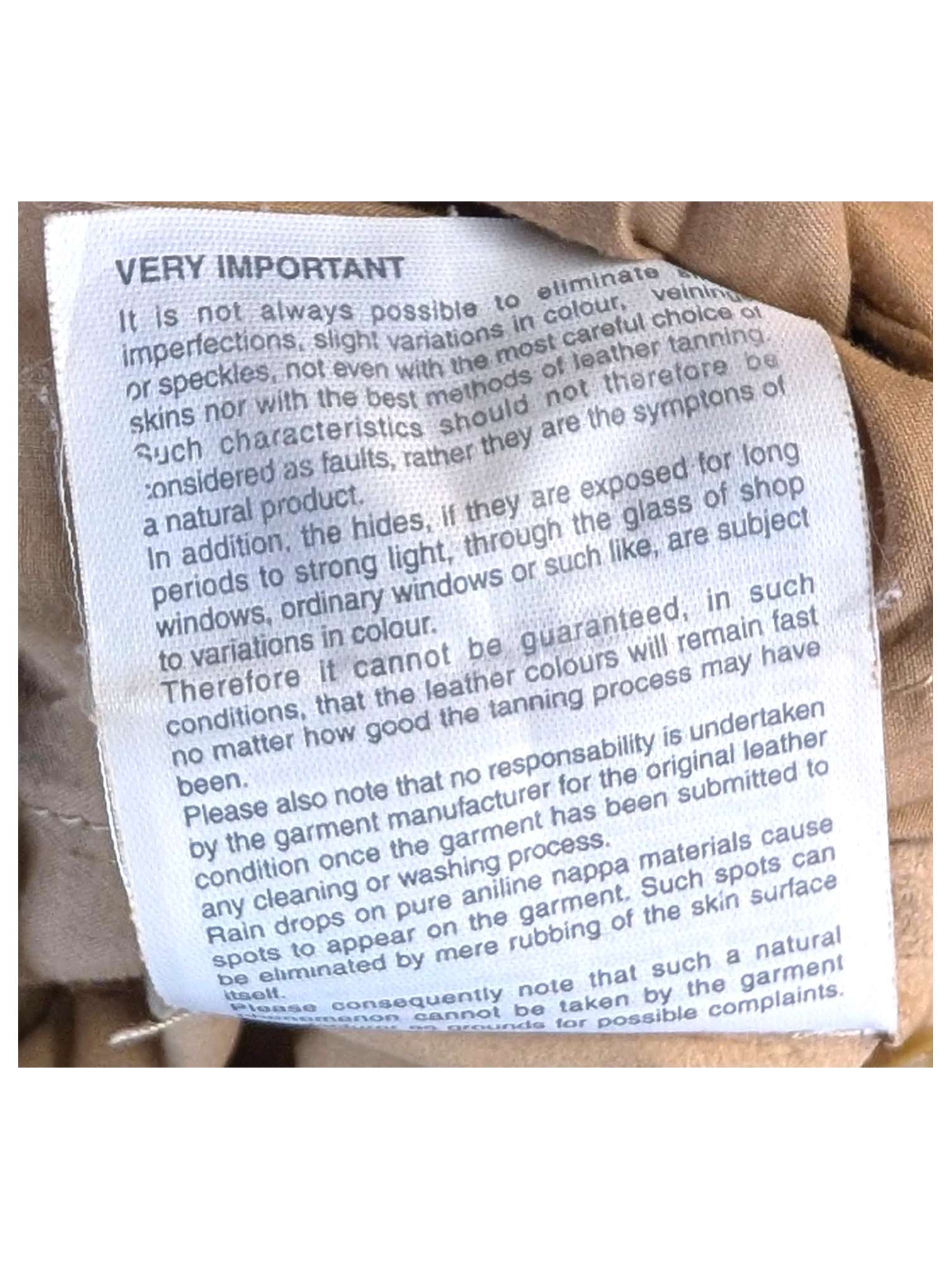 JAKE & IPI suede leather pants care instruction label inside beige garment