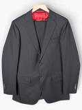JAKE & IPI Suitsupply black suit jacket with a vibrant red interior lining and two-button closure.